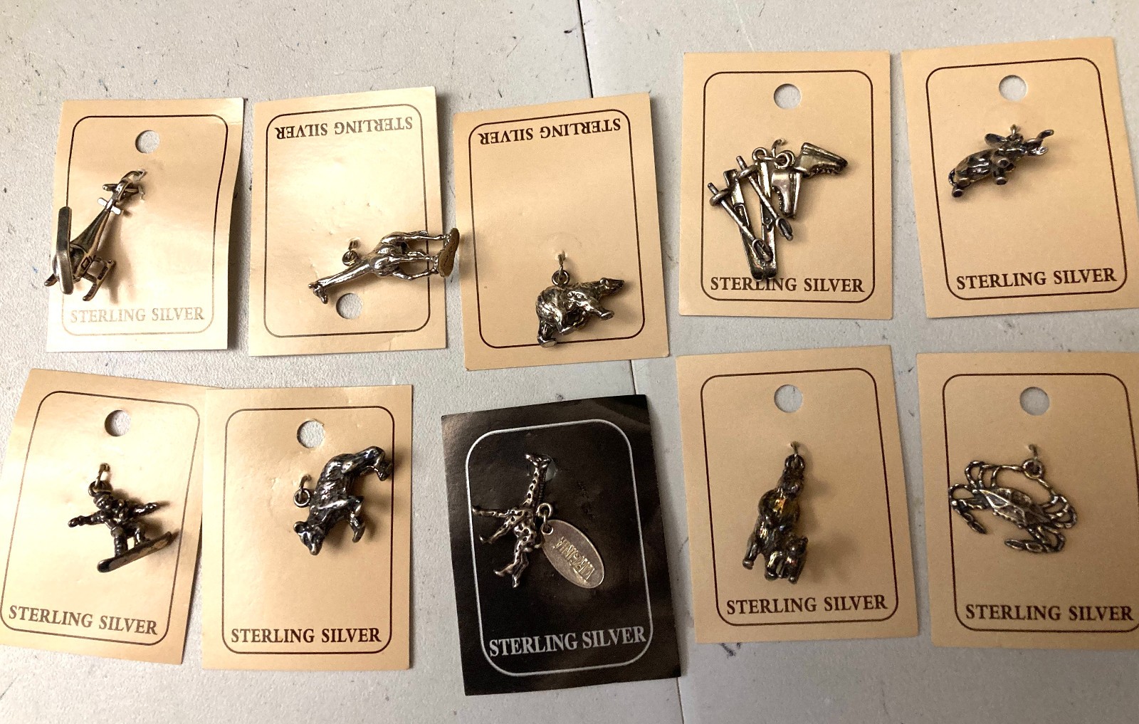 VINTAGE (10 ) DIFFERENT STERLING .925 CHARMS STILL ON CARDS N.O.S.