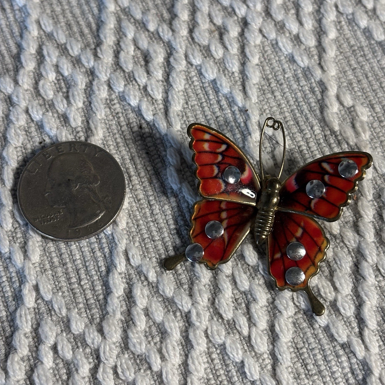 Butterfly Brooch or Pendant of Red Orange and Cream Resin on Gold Tone Setting.