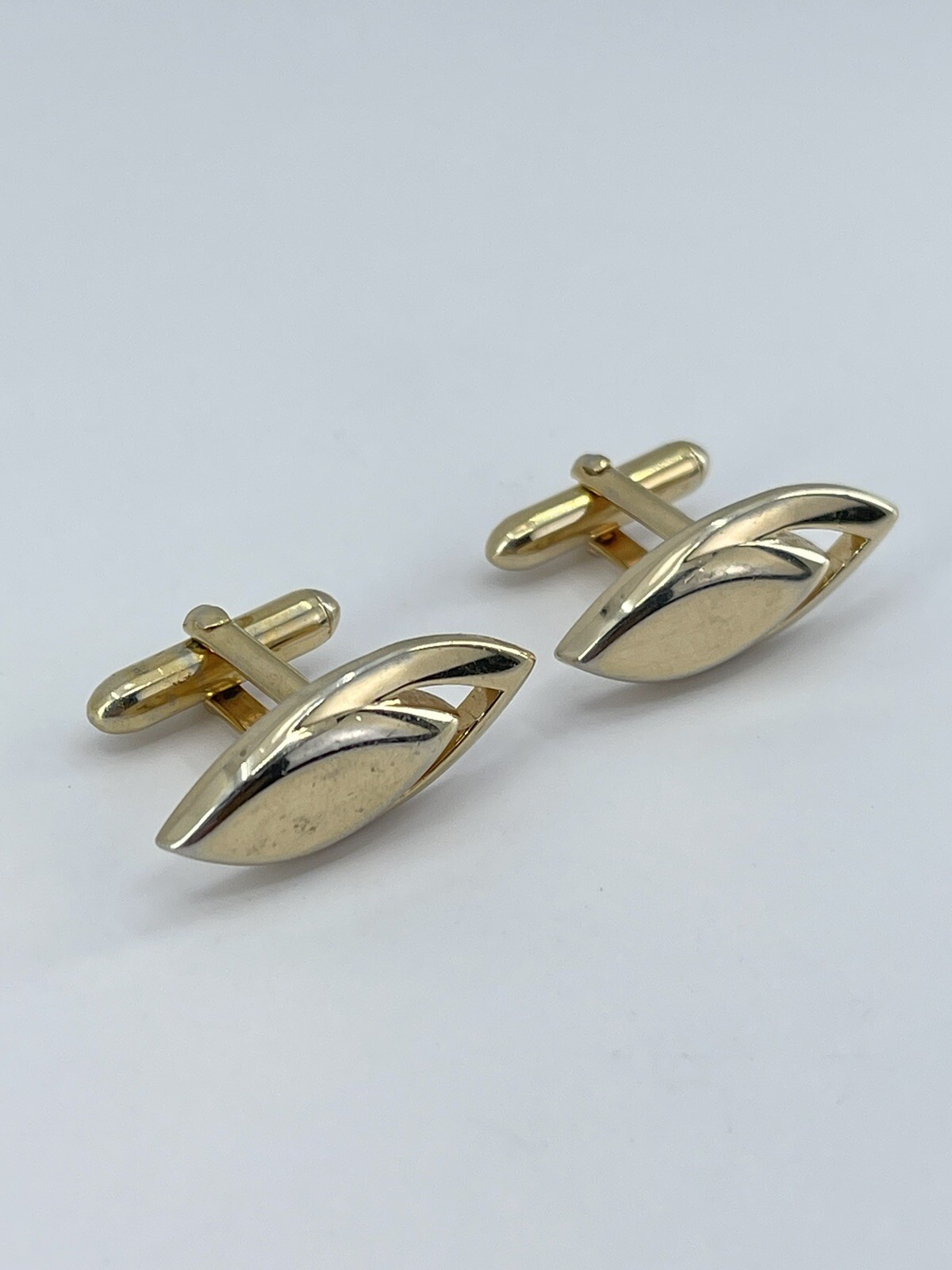 Vintage Swank mens cufflinks torpedo shaped raised cutout design gold tone 3/4″