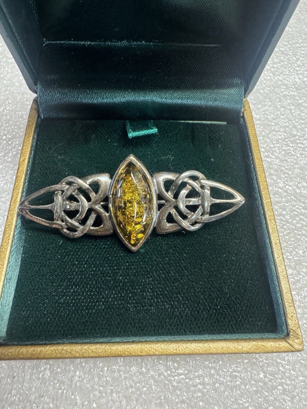 Kit Heath sterling silver brooch features a marquise-cut amber stone