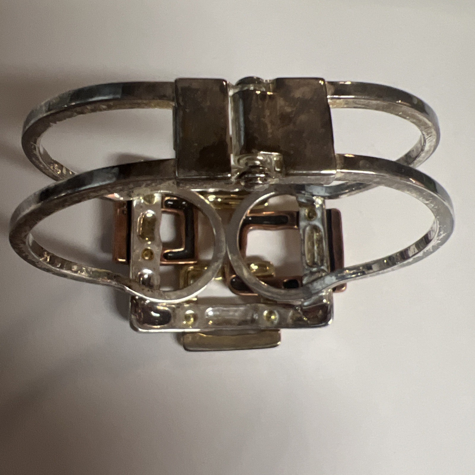 Brutalist mixed metal cuff bracelet, geometric silver and gold tone squares.
