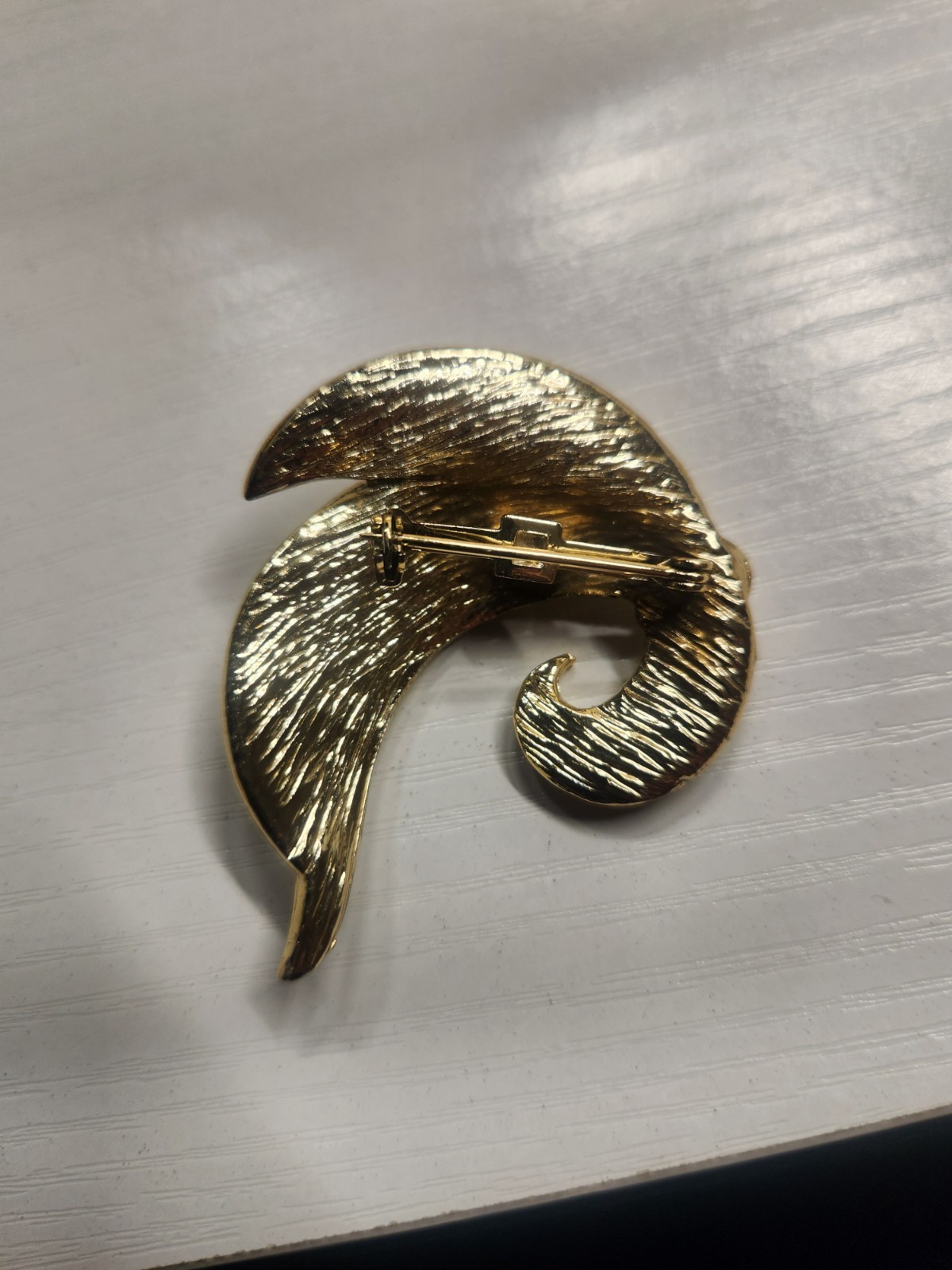 vintage, gold-tone, textured, double-leaf brooch, likely in the 1950s and 1980s.