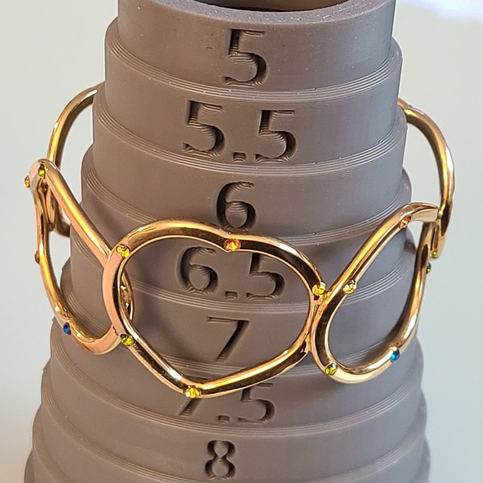 Gold-Tone Open Heart Hinged Cuff Bracelet with Multi-Color Rhinestones.