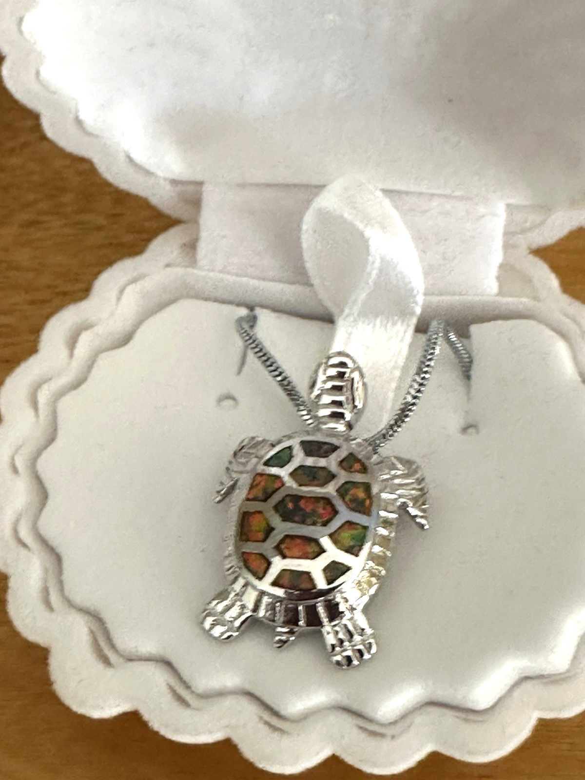 Sea turtle pendant featuring orange fire opals. Sterling silver chain. Shell box