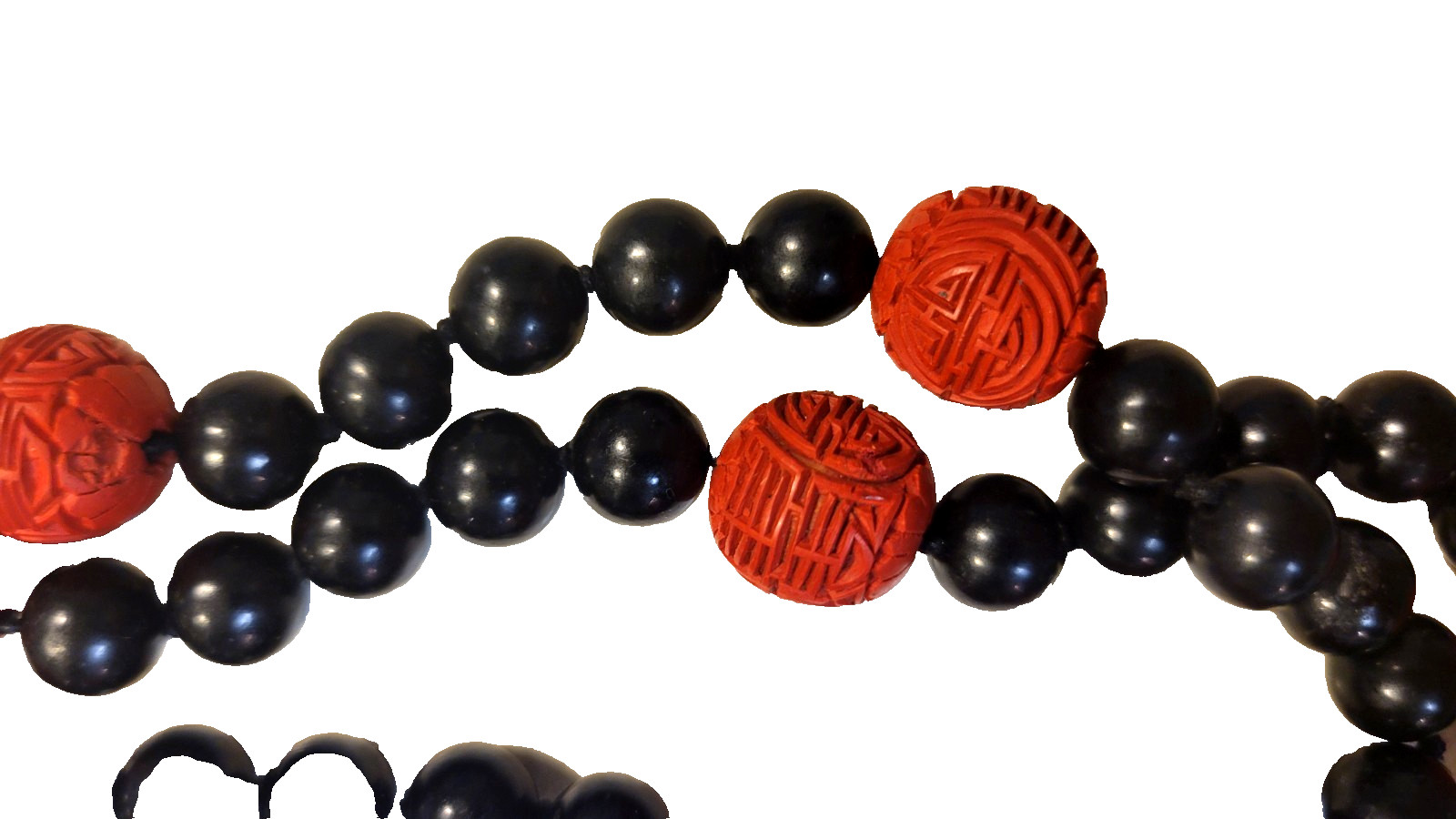 Cinnabar and black obsidion necklase 30″ hand knotted no clasp. 11 carved red lg