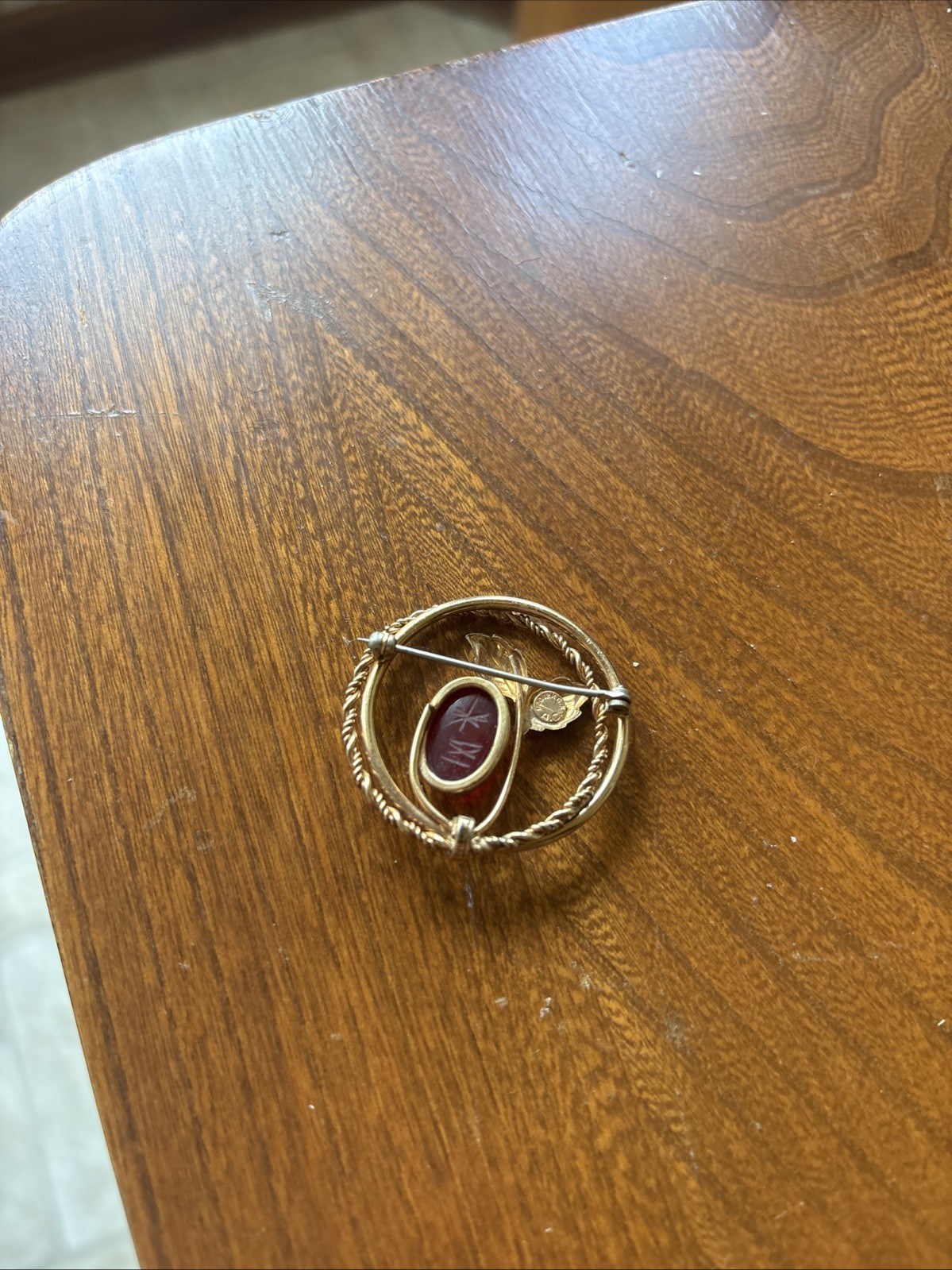 V20 12k “A.C.” Engraved Gold Tone Plant And Red Stone Brooch