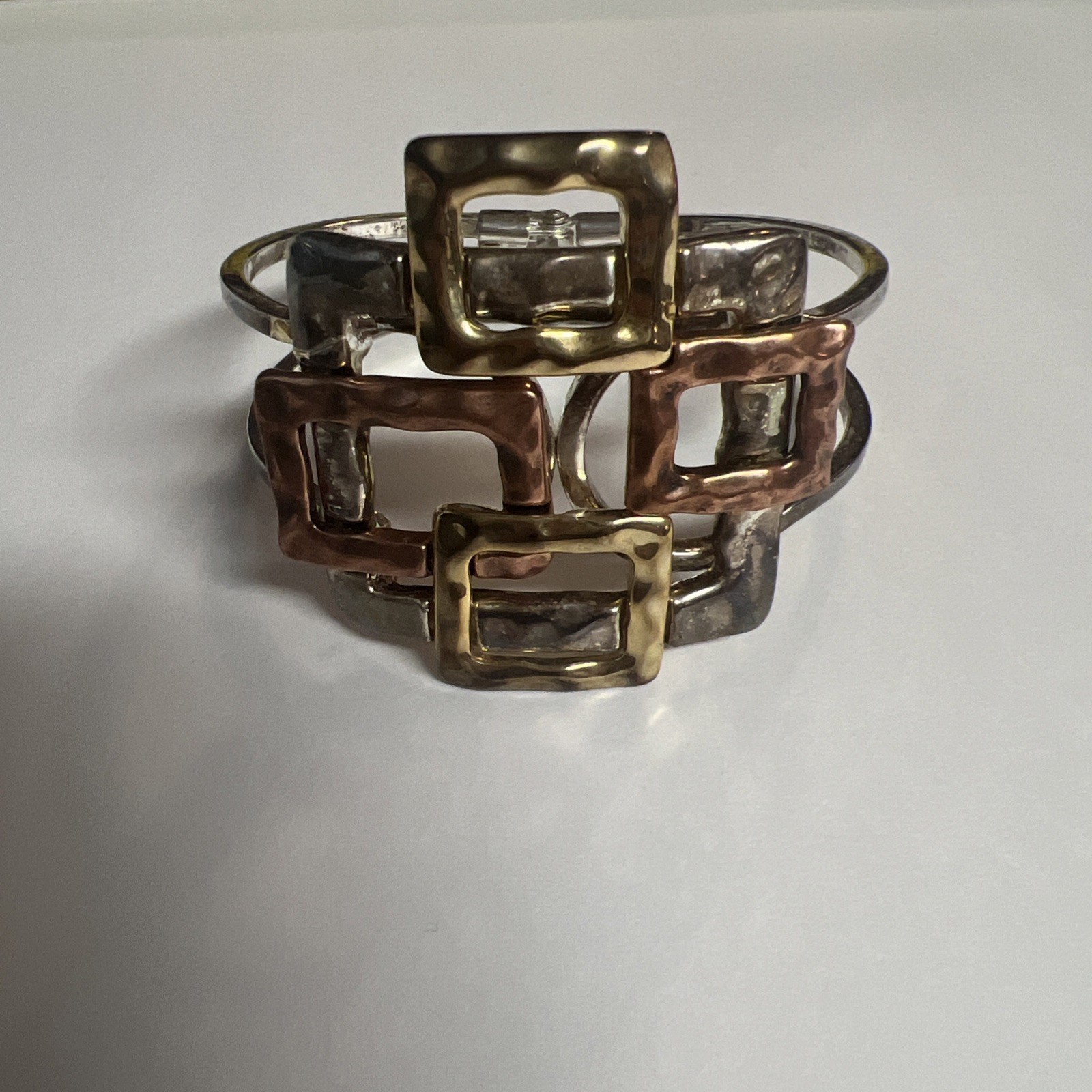 Brutalist mixed metal cuff bracelet, geometric silver and gold tone squares.