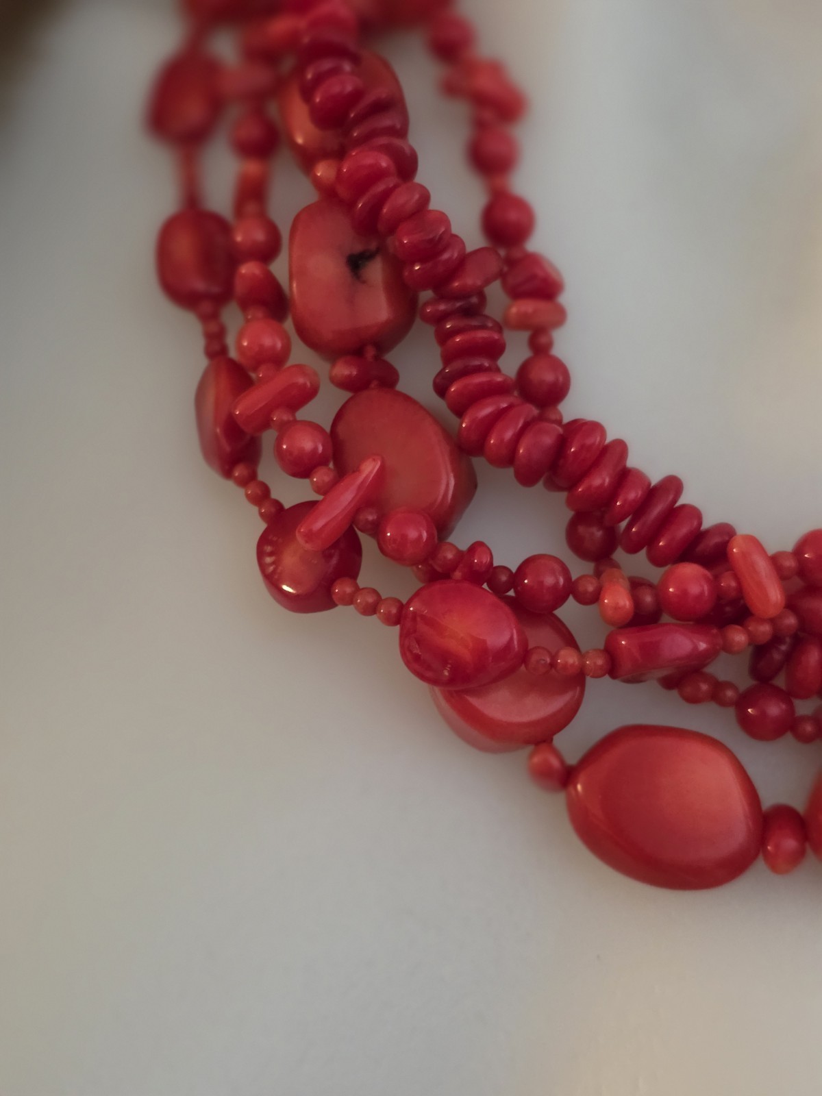 multi-strand red coral bead necklace Different shapes and sizes.