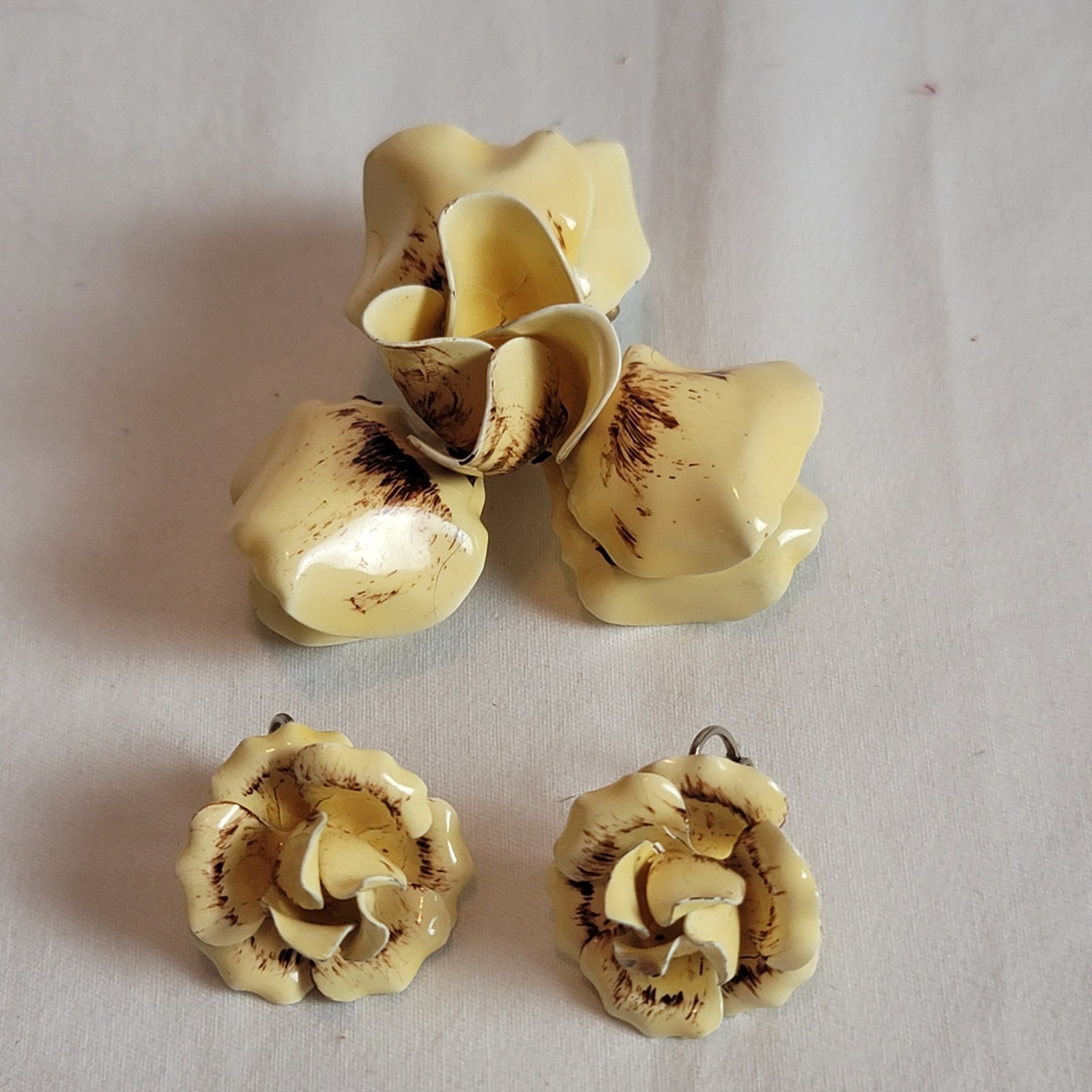 vintage floral clip-on earrings and brooch with a cream and brown enamel finish