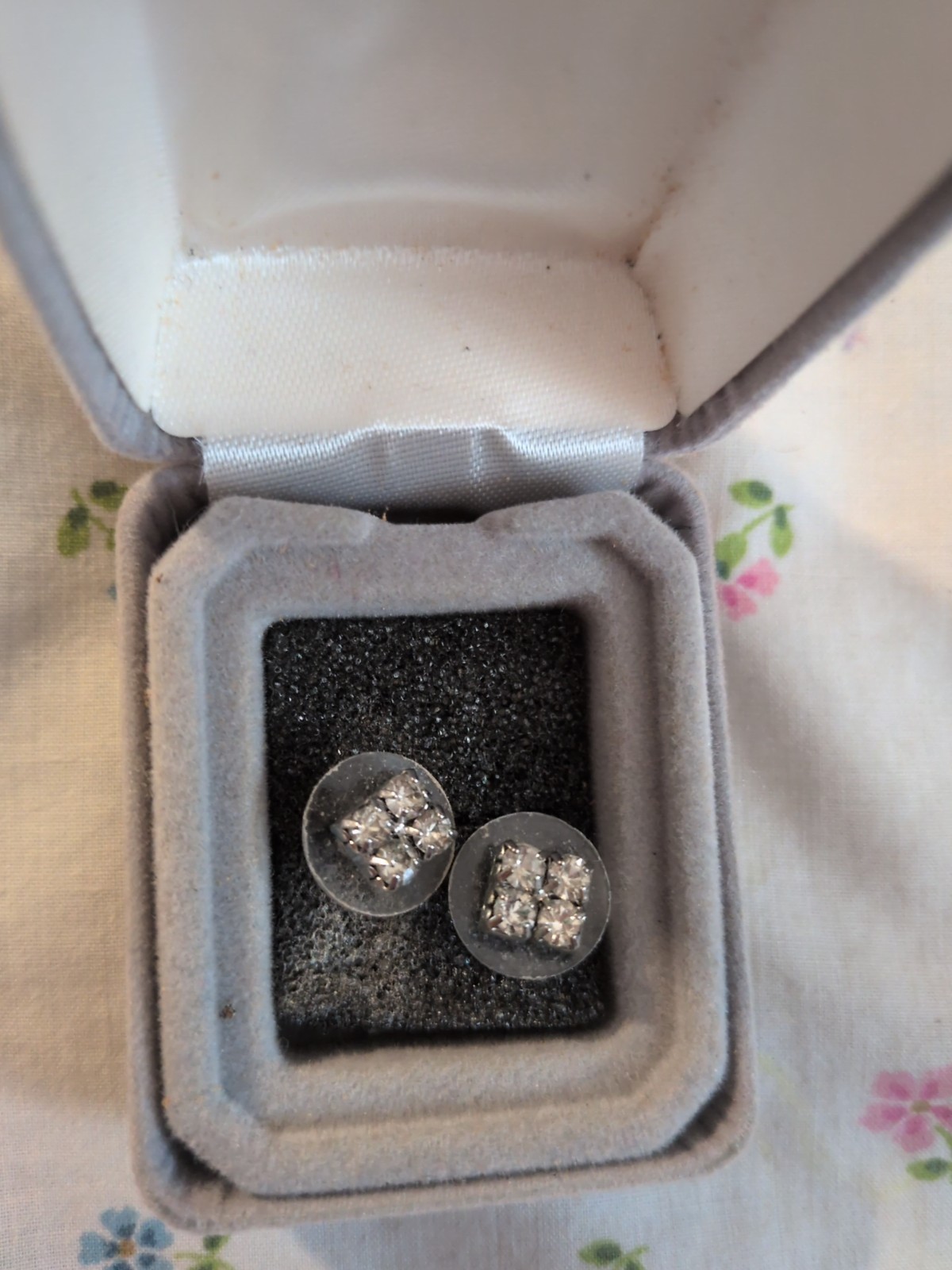 Earrings are rhinestone cluster earrings – silver-tone base.