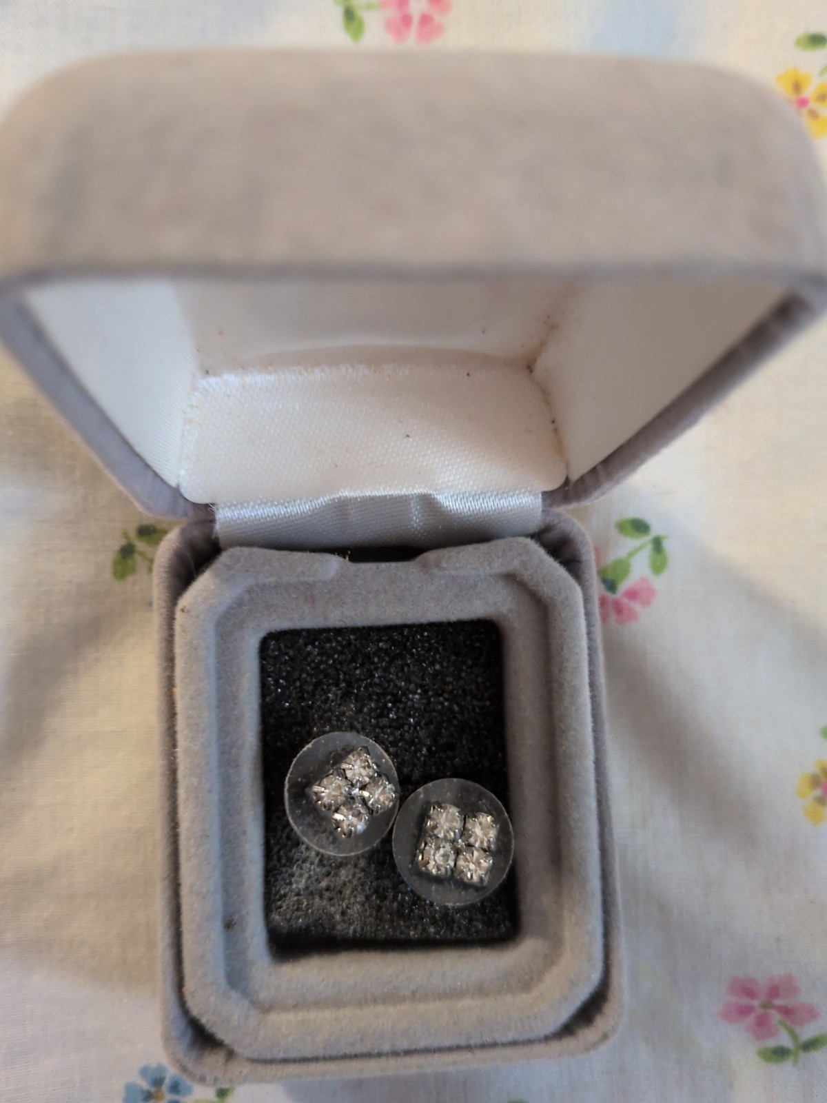 Earrings are rhinestone cluster earrings – silver-tone base.