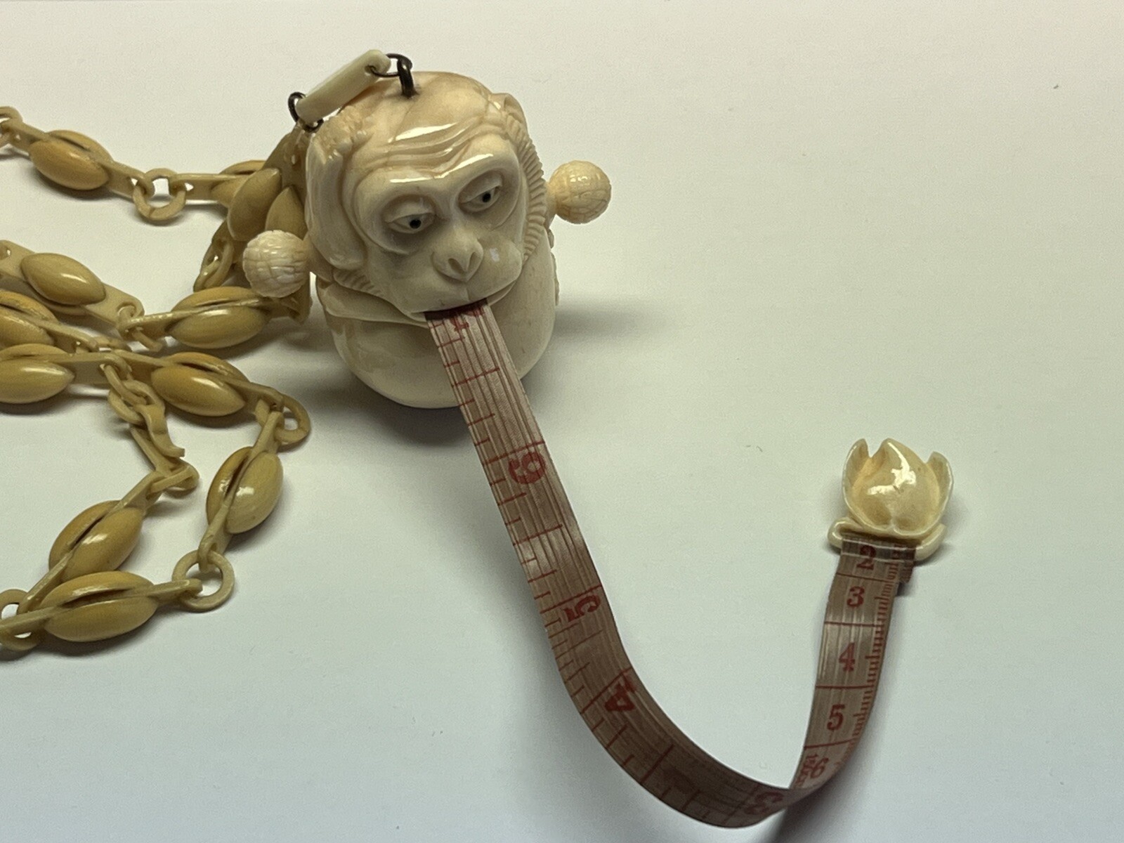 ANTIQUE ART DECO MONKEY NECKLACE TAPE MEASURE CELLULOID CHAIN PENDANT WHIMSICAL
