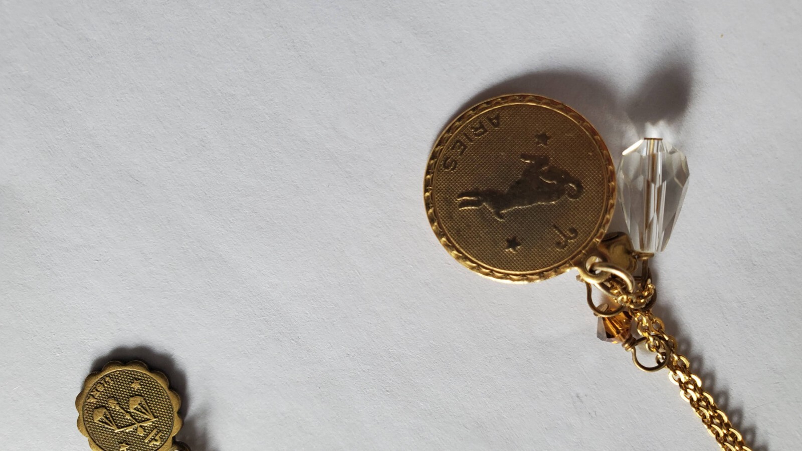 Vintage two gold tone zodiak necklaces, one designer’s Danielle Stevens