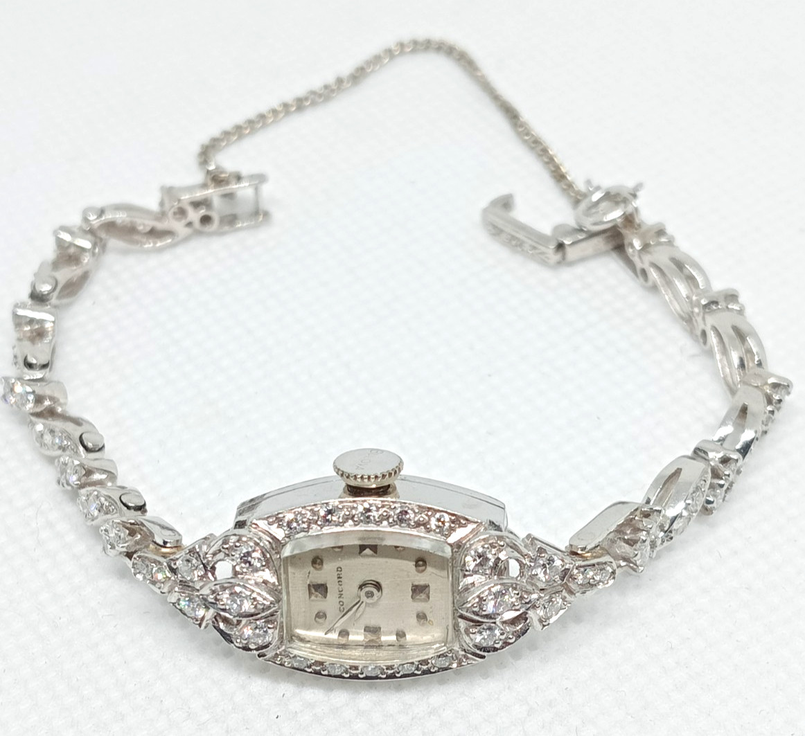 STAMPED IRID PLATINUM MANUAL CONCORD LADIES DIAMOND WRIST WATCH