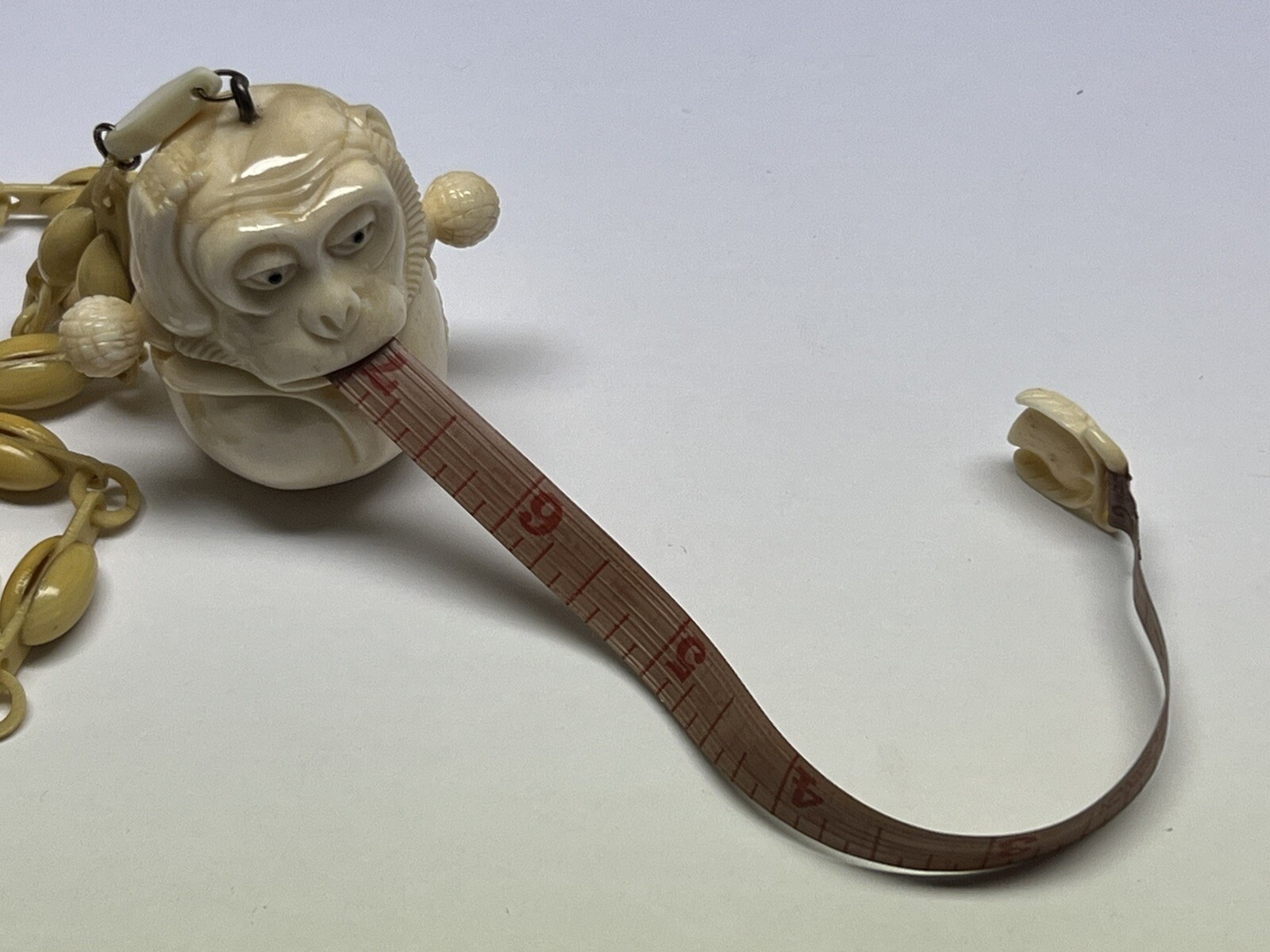 ANTIQUE ART DECO MONKEY NECKLACE TAPE MEASURE CELLULOID CHAIN PENDANT WHIMSICAL