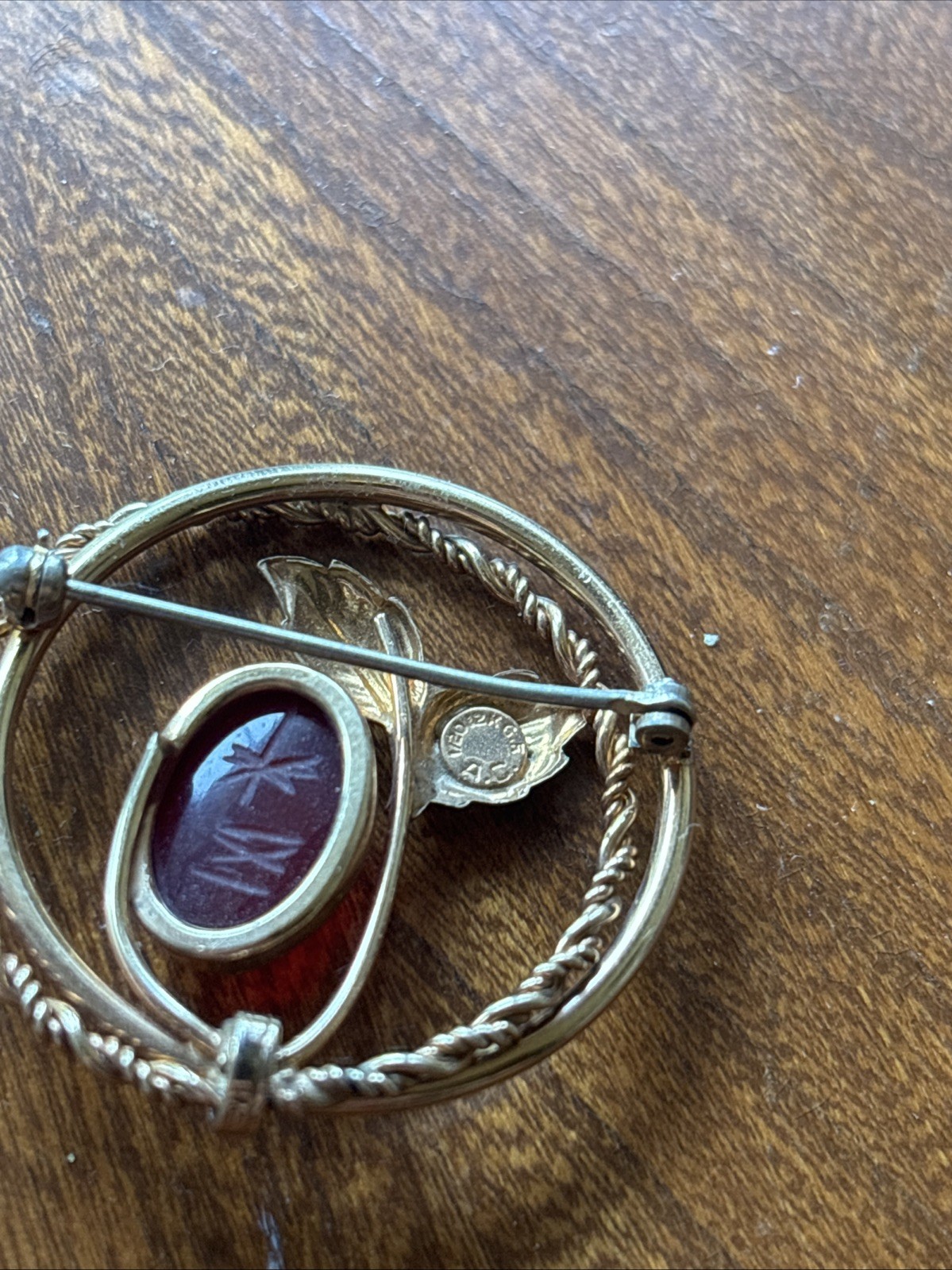 V20 12k “A.C.” Engraved Gold Tone Plant And Red Stone Brooch