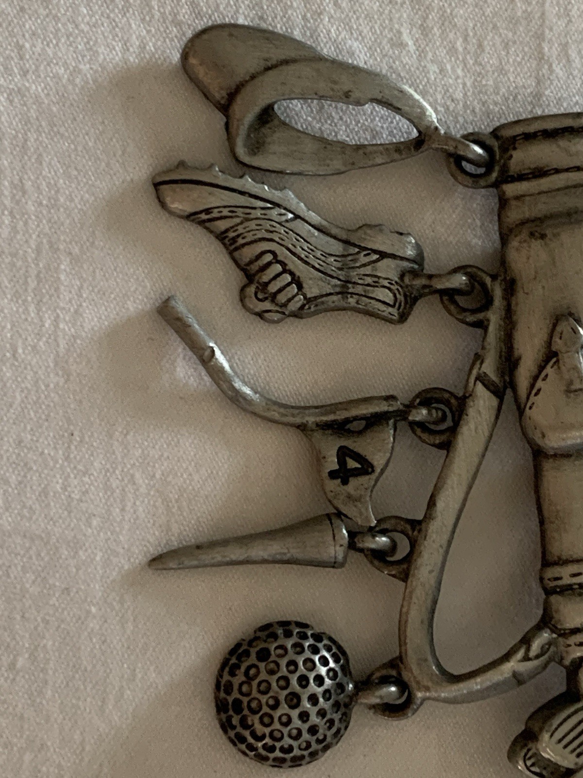 Jonette Jewelry (JJ) golf-themed brooch made of pewter or a similar alloy