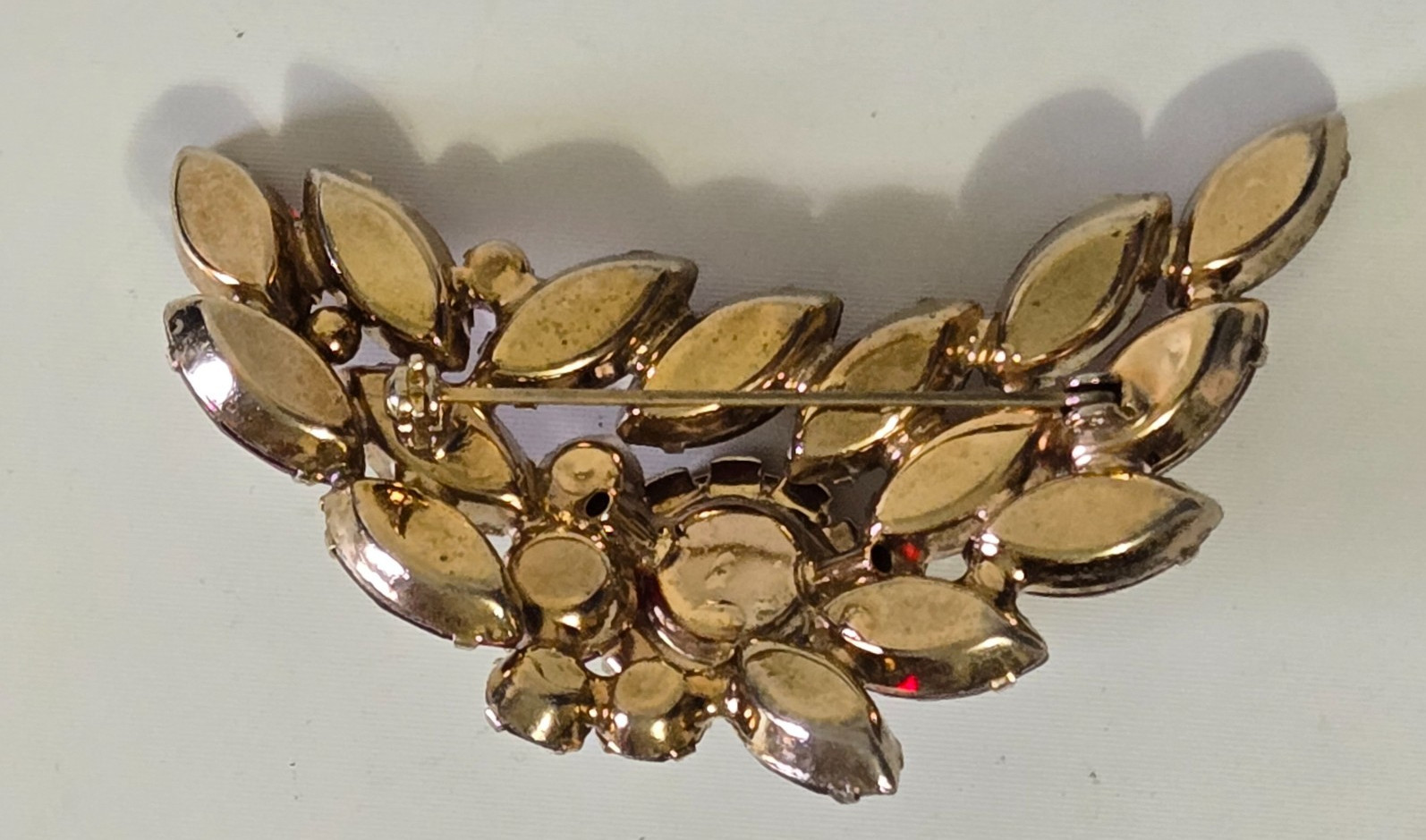 Vintage Brooch. Goldtone with Dark Red Stones. Pink Accent Stones. Gorgeous.