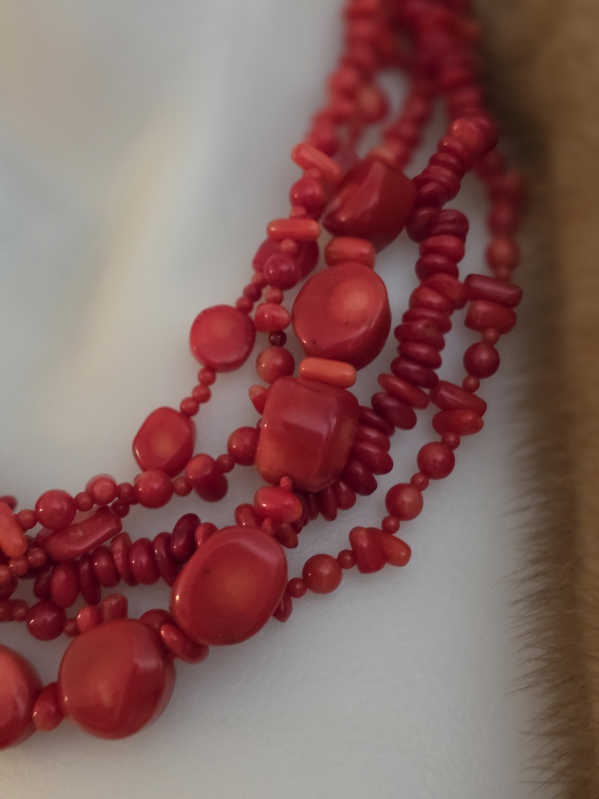 multi-strand red coral bead necklace Different shapes and sizes.