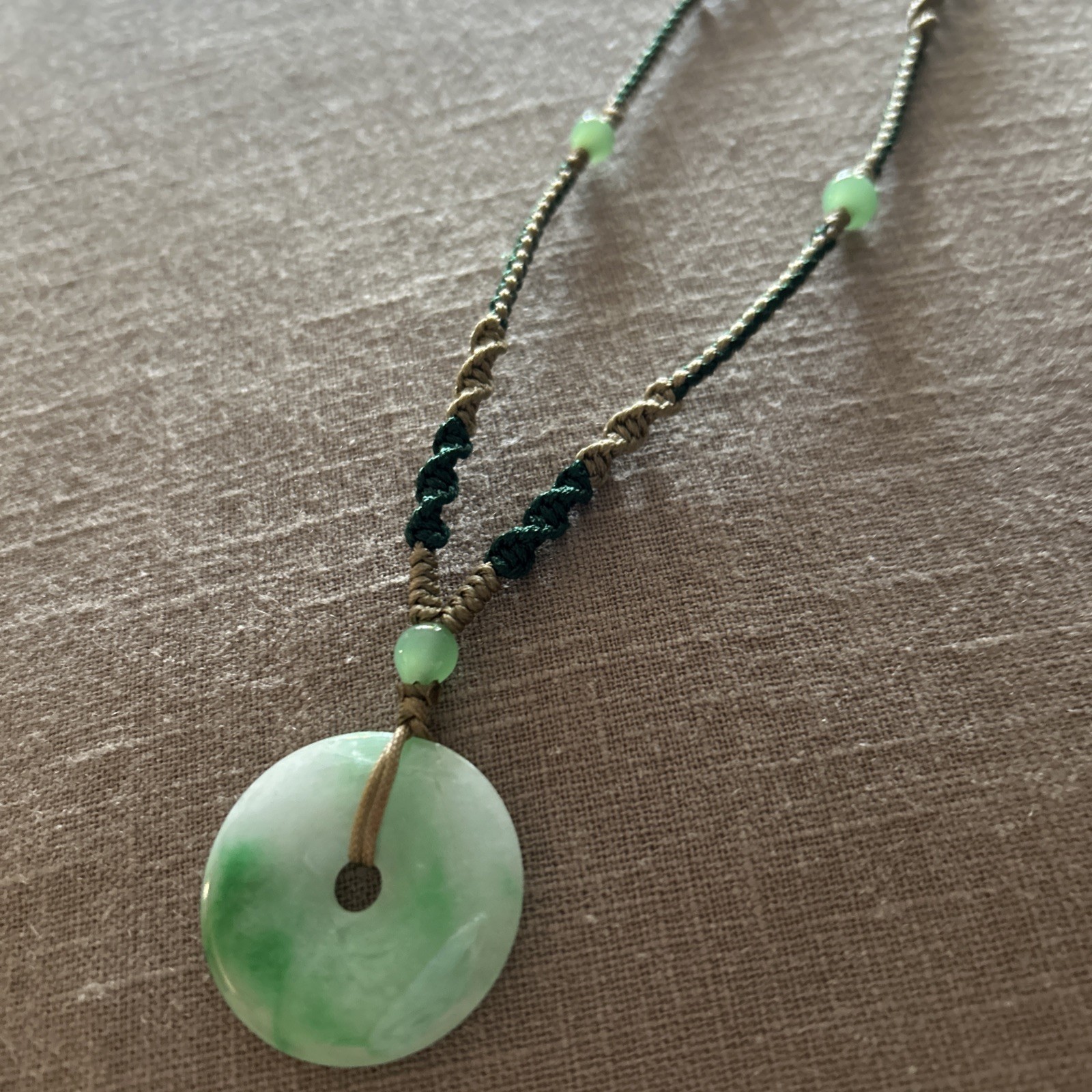 Vintage Green Jade Pendant 1-1/8” on a braided tan and green cord w/3 jade beads