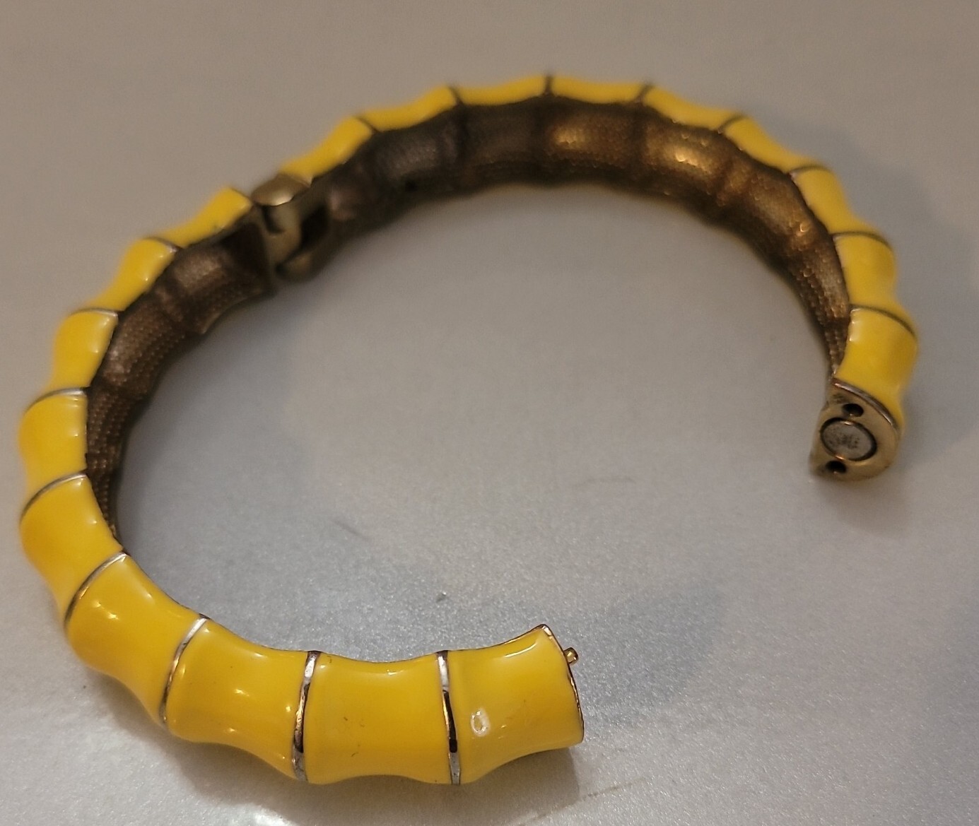 Hinged clamper Yellow bracelet on shapely goldton jewelry