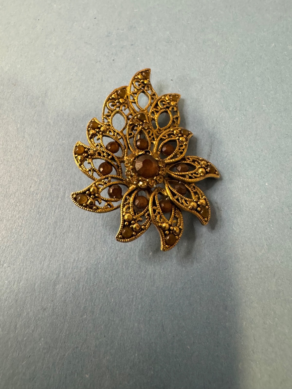 Gold Tone Brooch with Amber and Brown Glass Stones In A Floral or Leaf Design