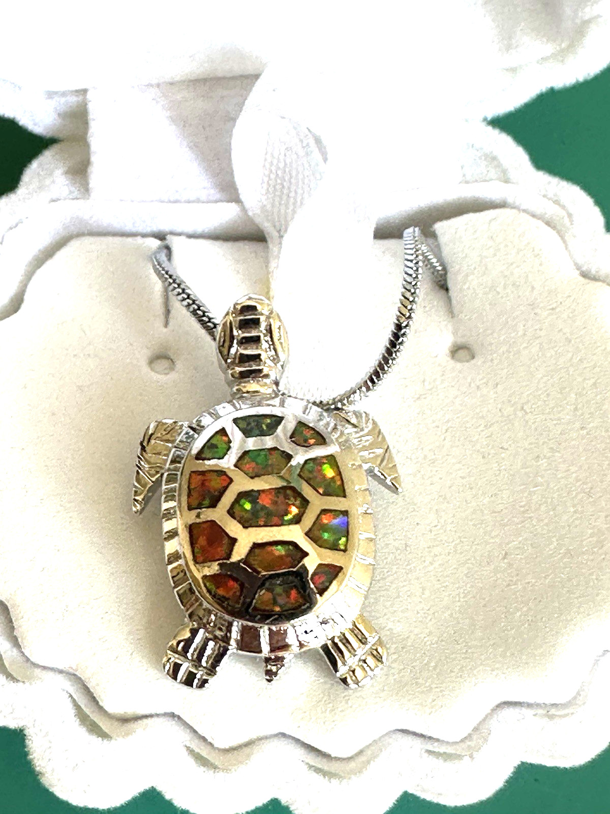 Sea turtle pendant featuring orange fire opals. Sterling silver chain. Shell box