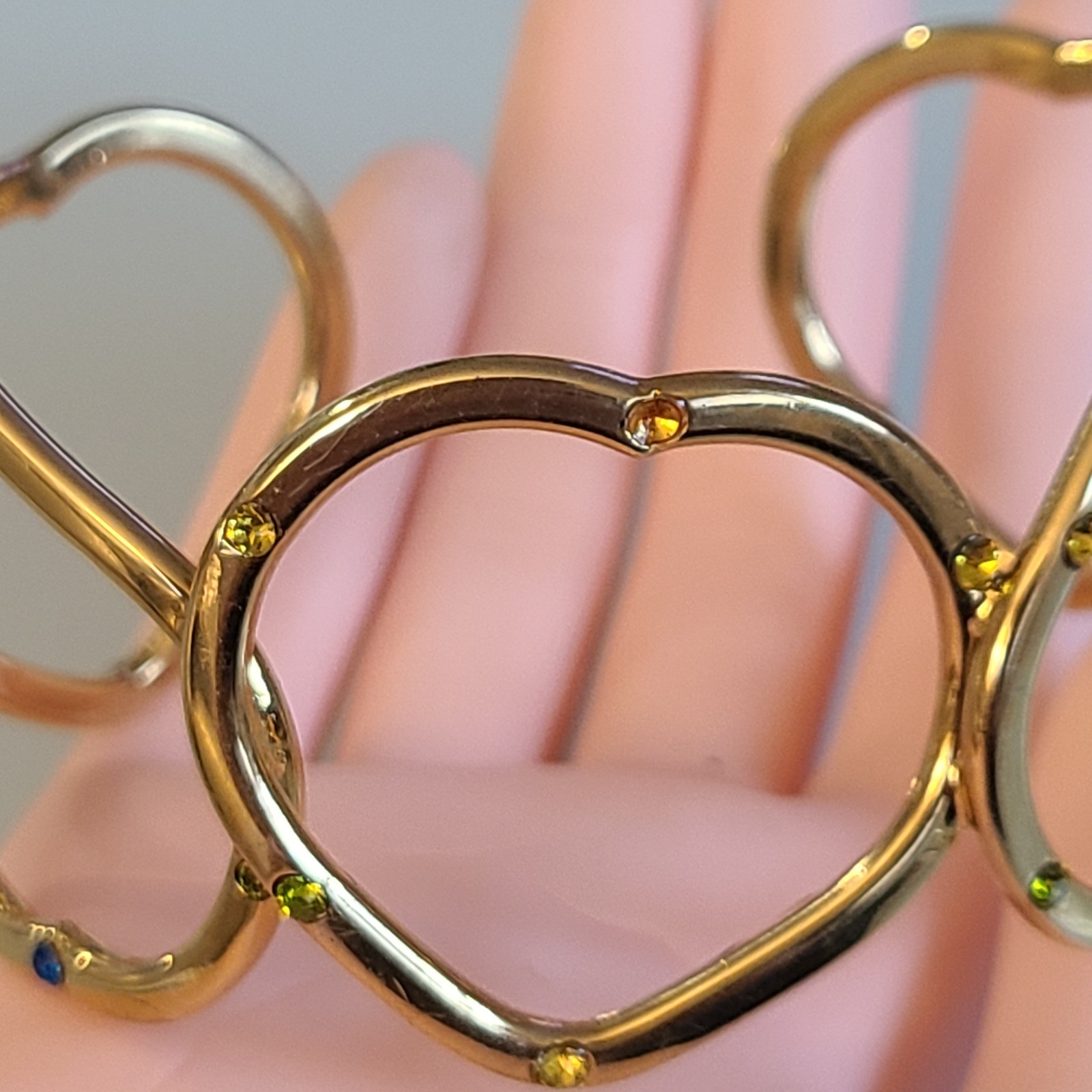 Gold-Tone Open Heart Hinged Cuff Bracelet with Multi-Color Rhinestones.