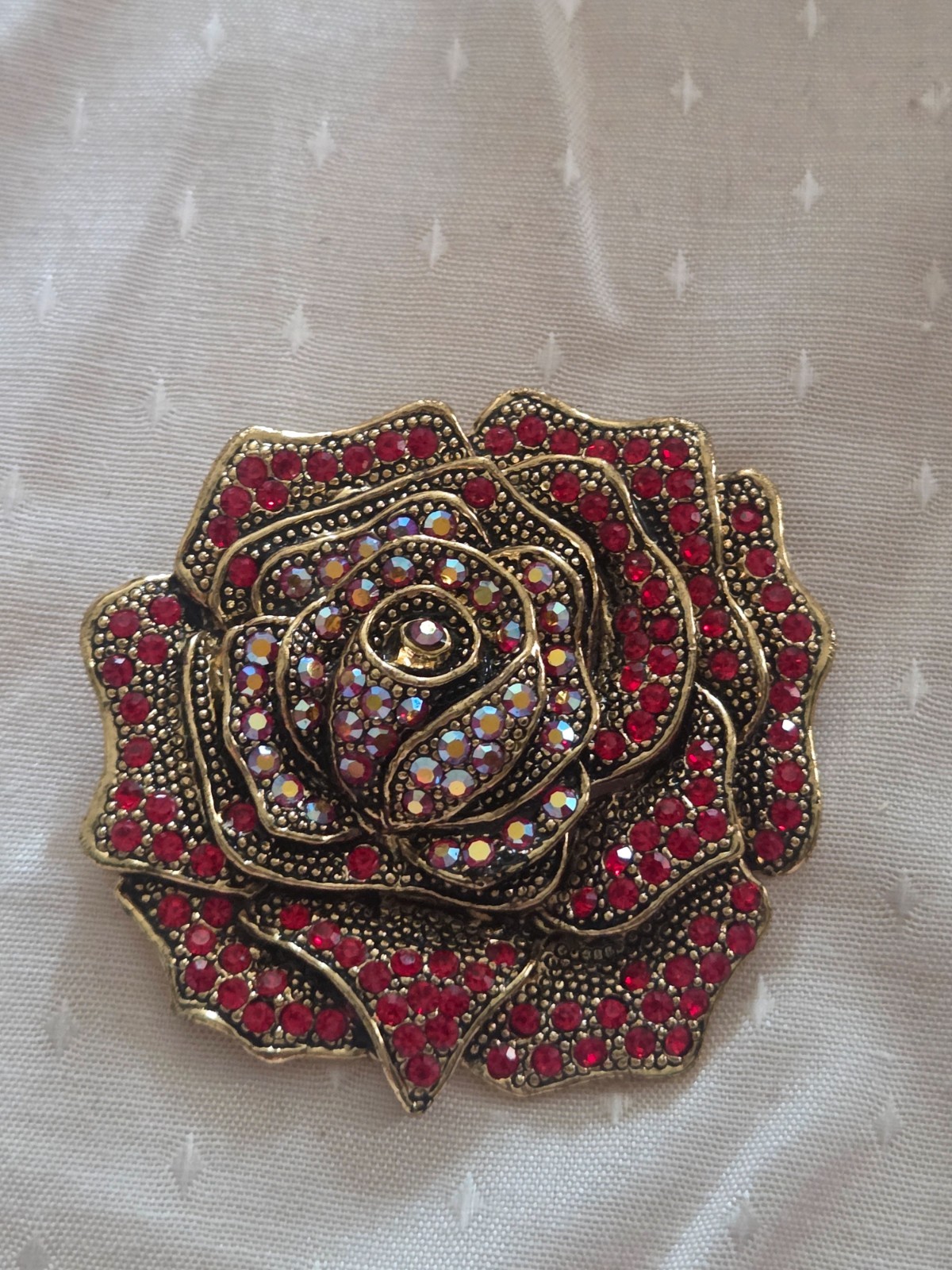 Heidi Daus “Ravishing Rose” brooch featuring red and iridescent crystals
