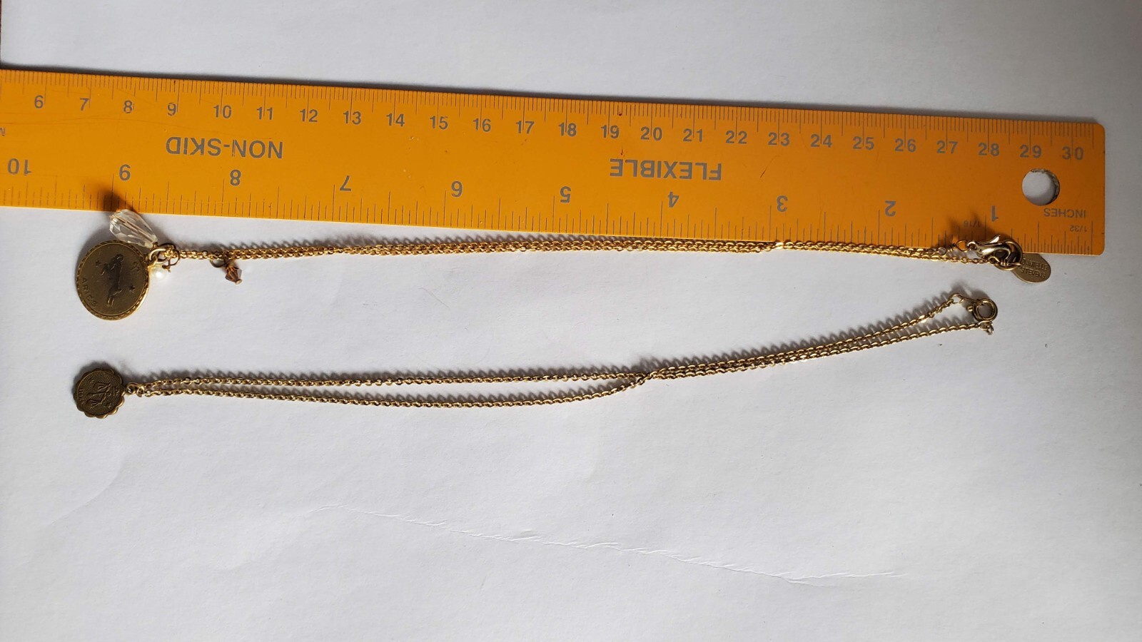 Vintage two gold tone zodiak necklaces, one designer’s Danielle Stevens