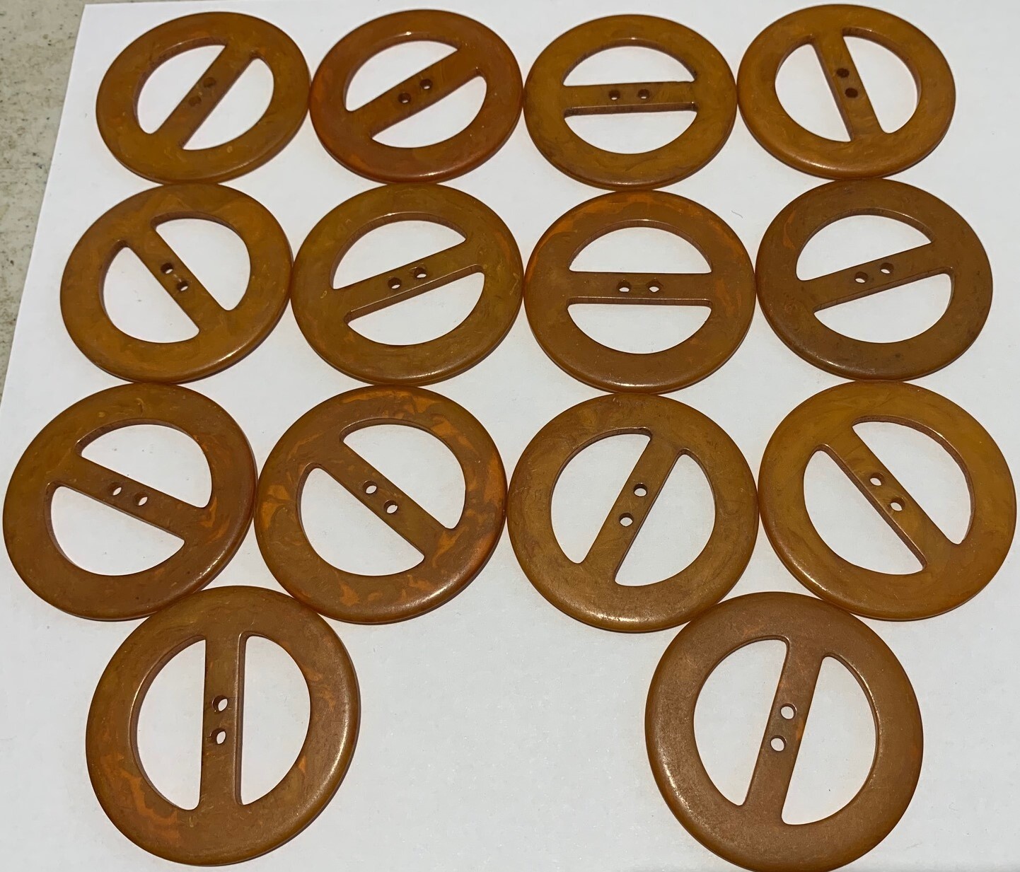 Swirled Bakelite Deco. Each is about 2″ wide and 1/16″ deep. Per piece price.
