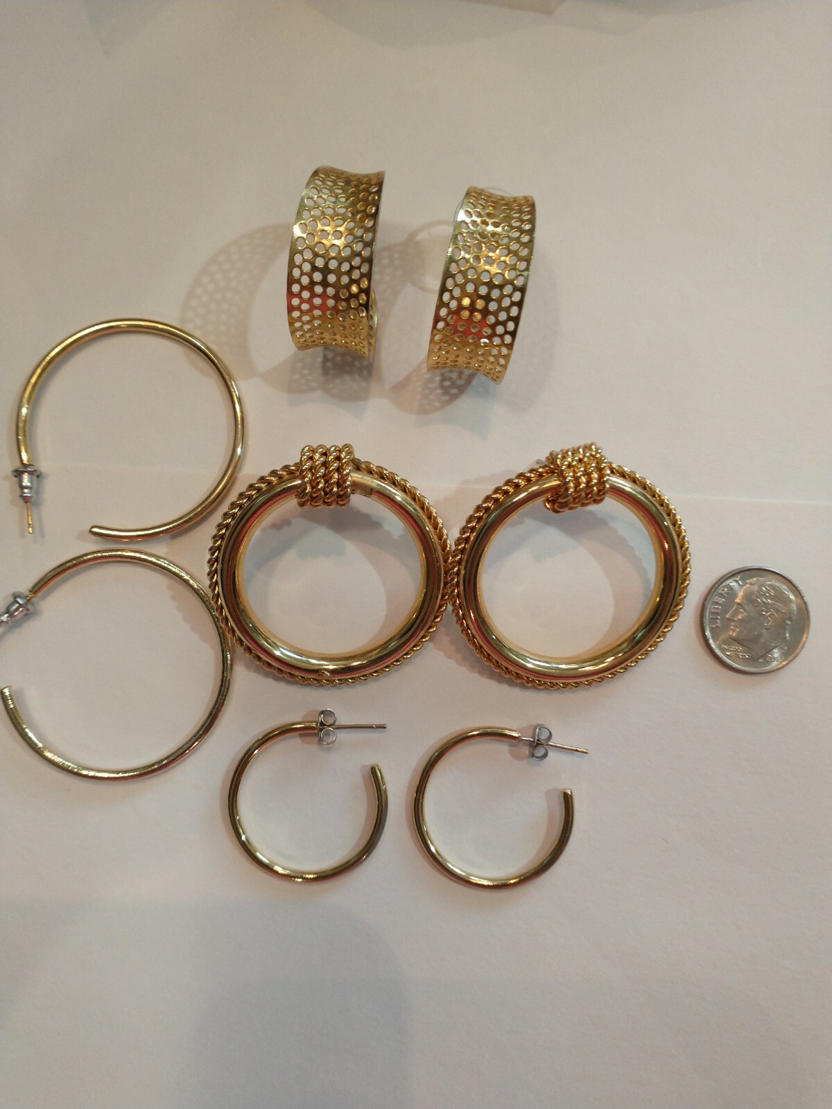 Four pair gold hoops different sizes and shapes pierced