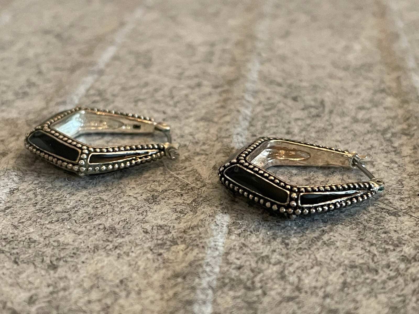 For auction is a Vintage MONET Silver Tone & Black Hoop Pierced Earring. Please