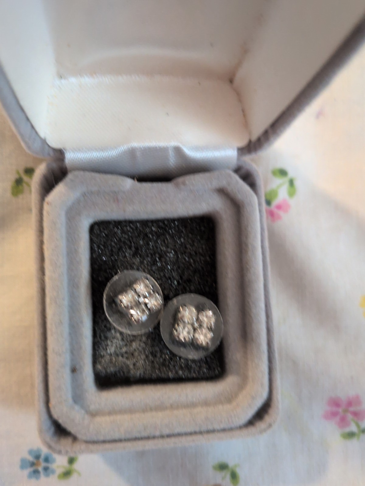 Earrings are rhinestone cluster earrings – silver-tone base.