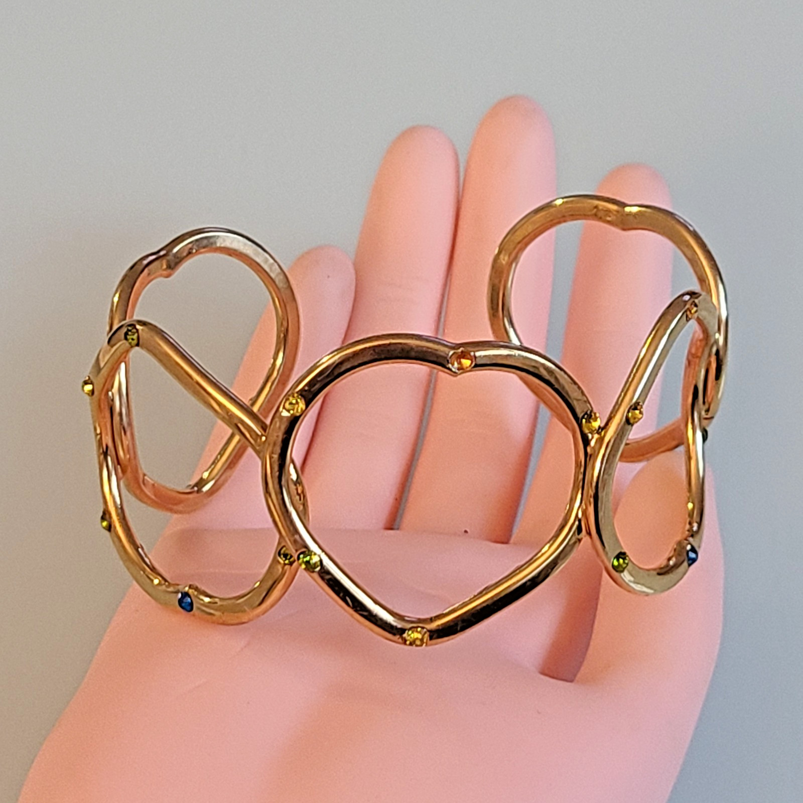 Gold-Tone Open Heart Hinged Cuff Bracelet with Multi-Color Rhinestones.