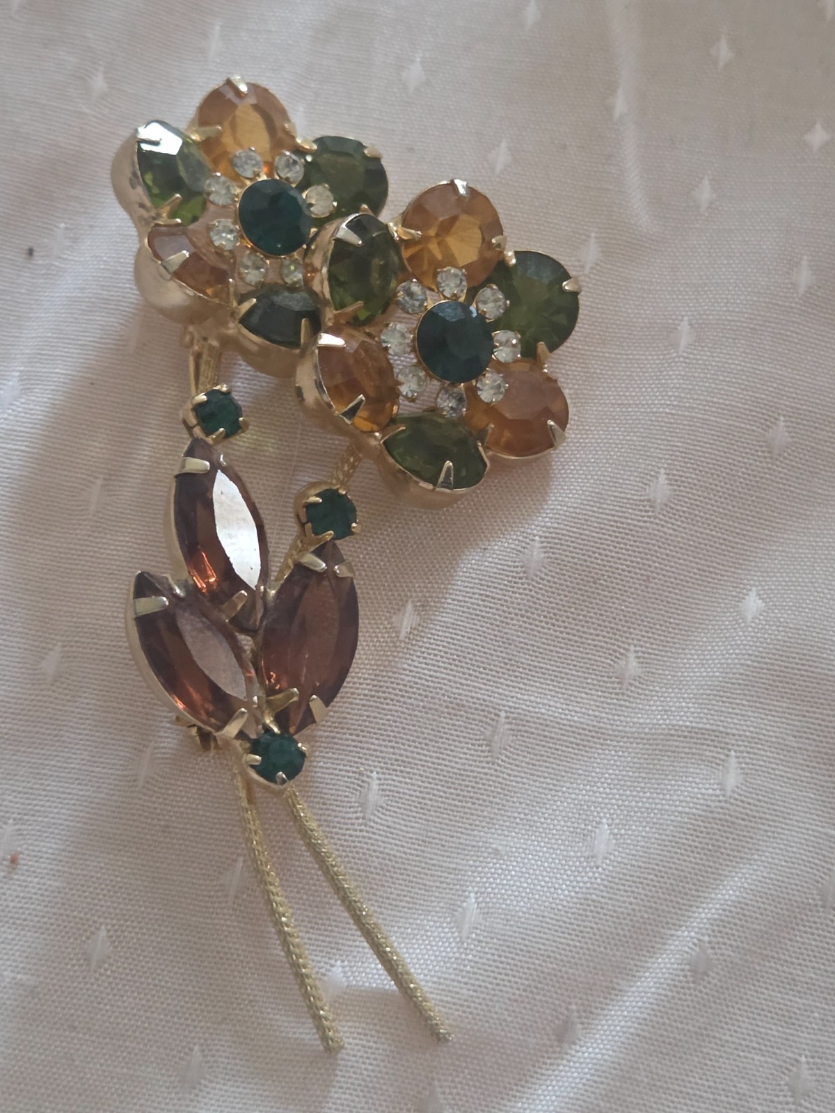 Juliana DeLizza & Elster floral brooch featuring green, amber, and yellow stones