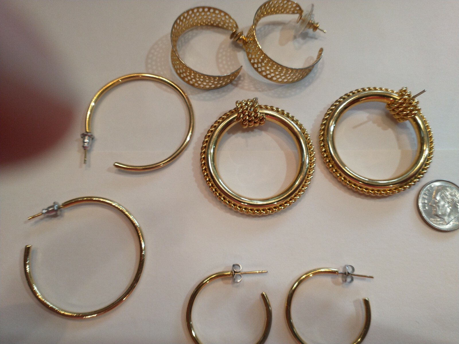 Four pair gold hoops different sizes and shapes pierced