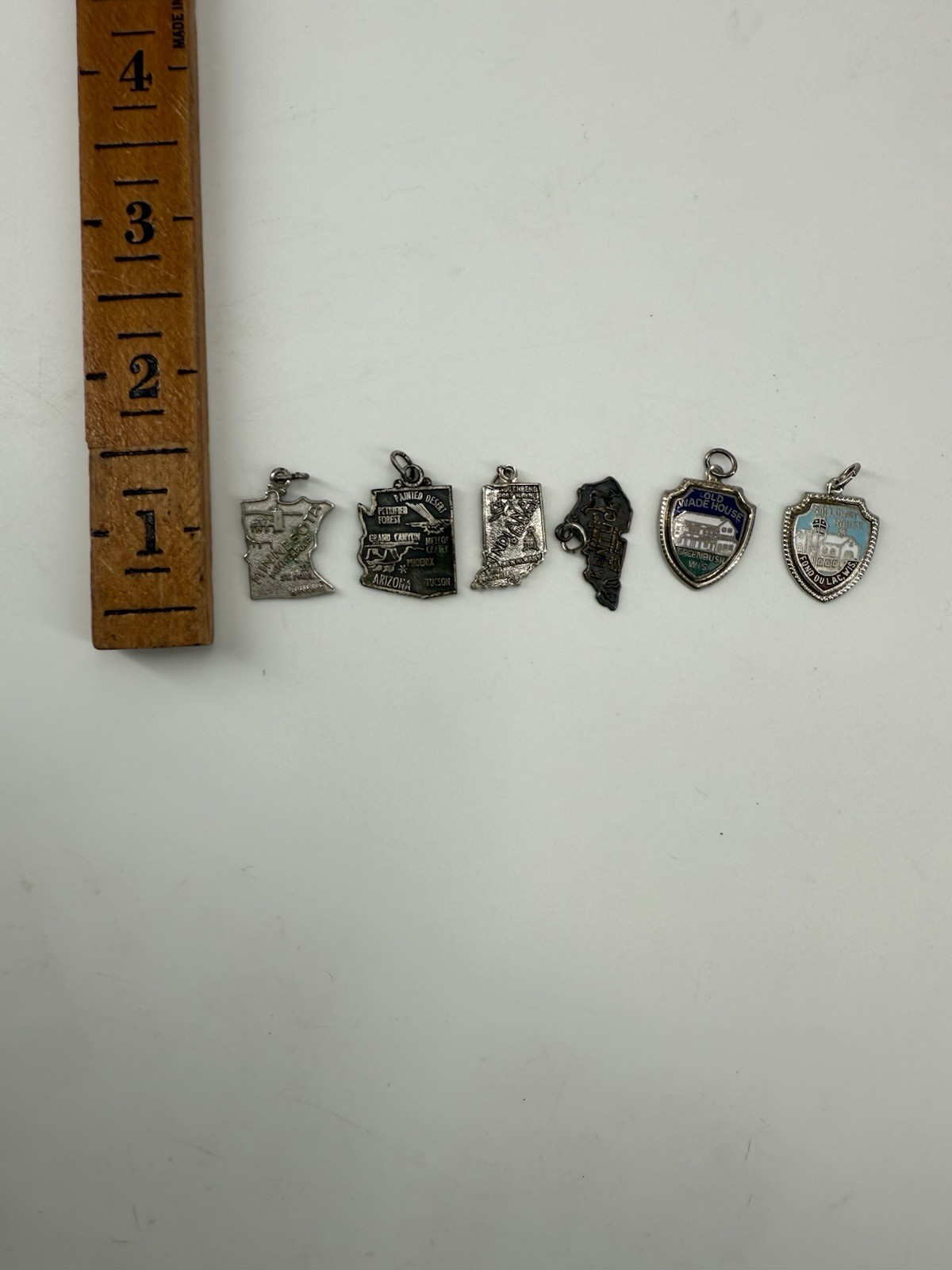 collection of vintage sterling silver souvenir charms from various locations