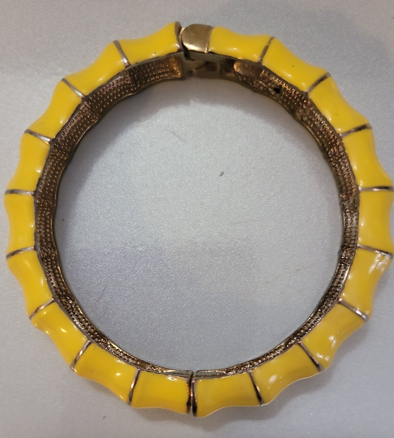 Hinged clamper Yellow bracelet on shapely goldton jewelry