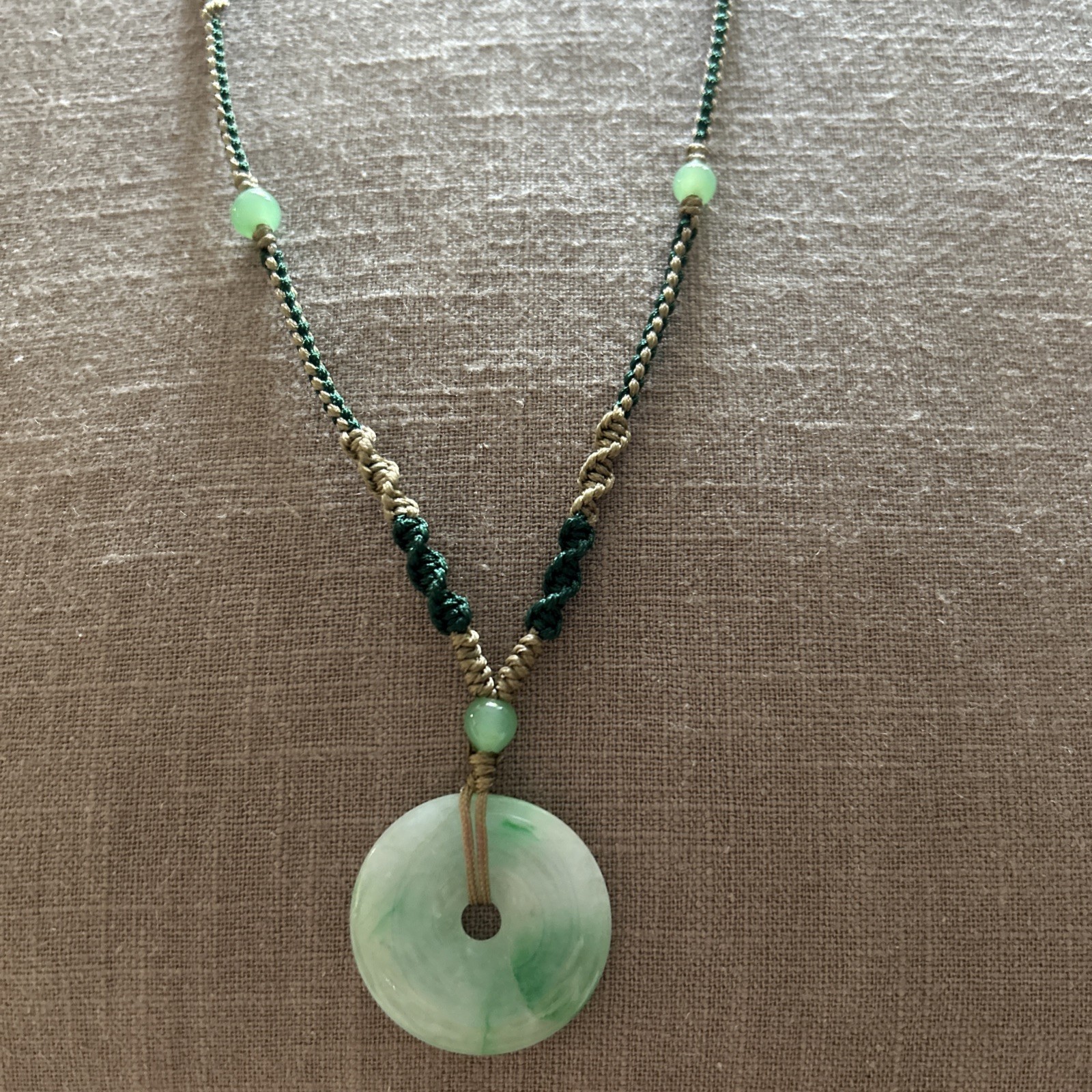 Vintage Green Jade Pendant 1-1/8” on a braided tan and green cord w/3 jade beads