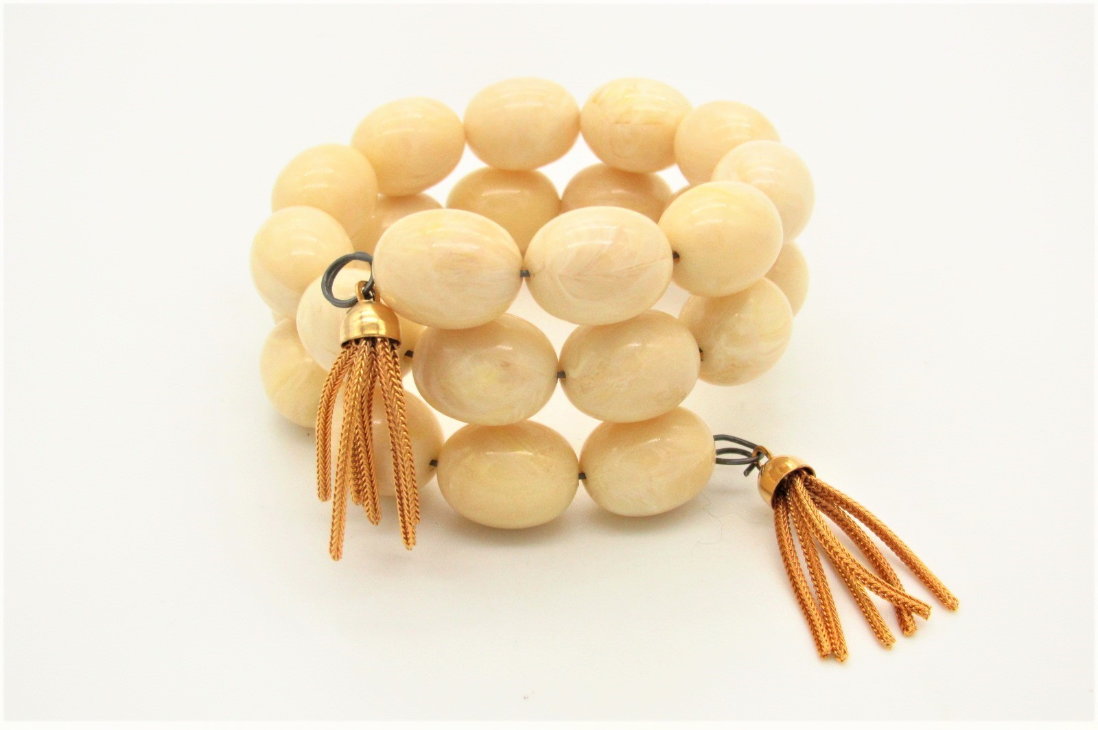 Vtg Coil Bracelet w/Faux Ivory Galalith Beads and Gold Tone Tassel Ends
