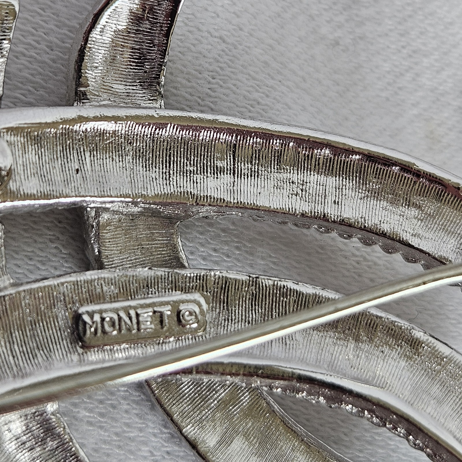 Vintage Monet Silvertone TEXTURED Twisted Ribbon Brooch approximately 2-1/8”