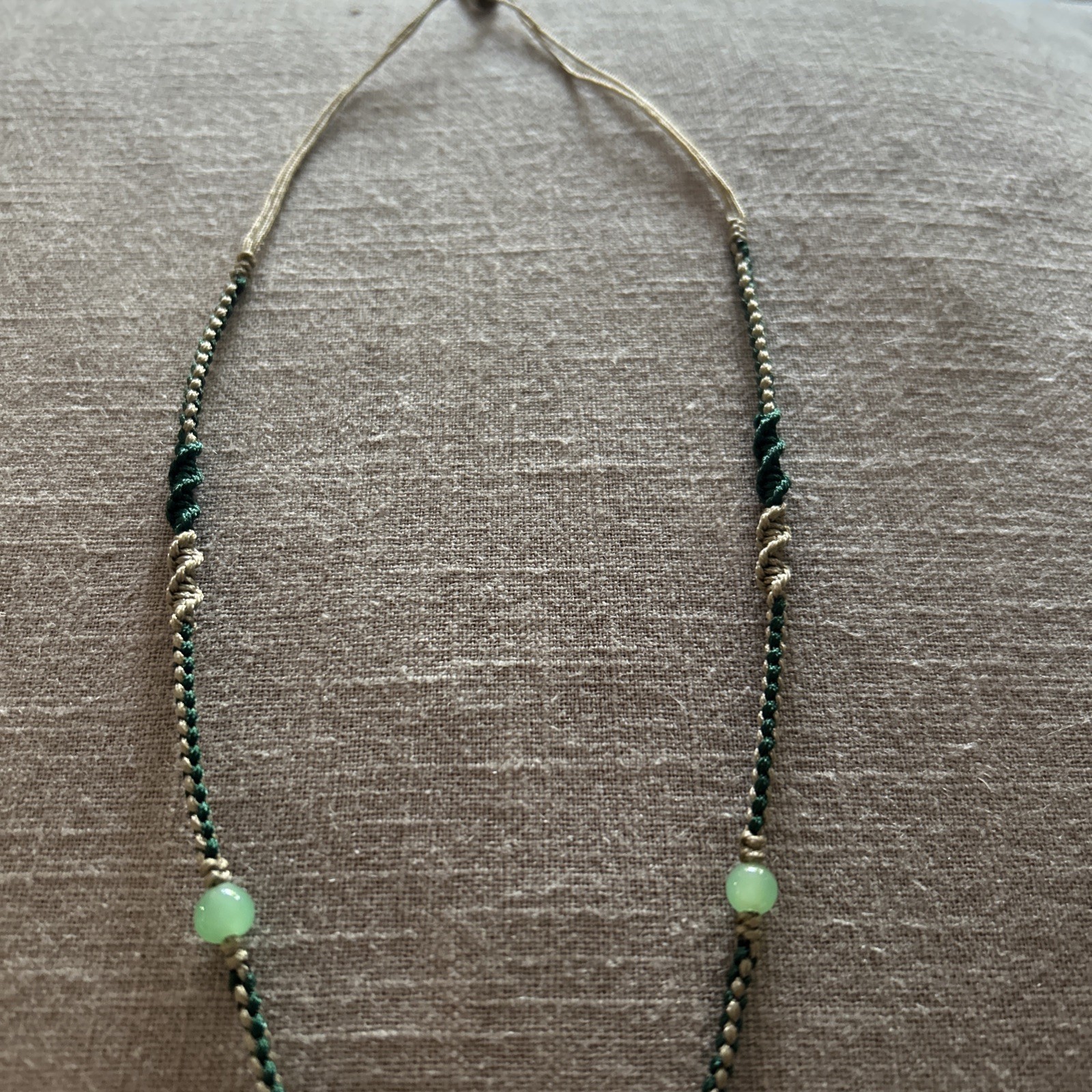 Vintage Green Jade Pendant 1-1/8” on a braided tan and green cord w/3 jade beads