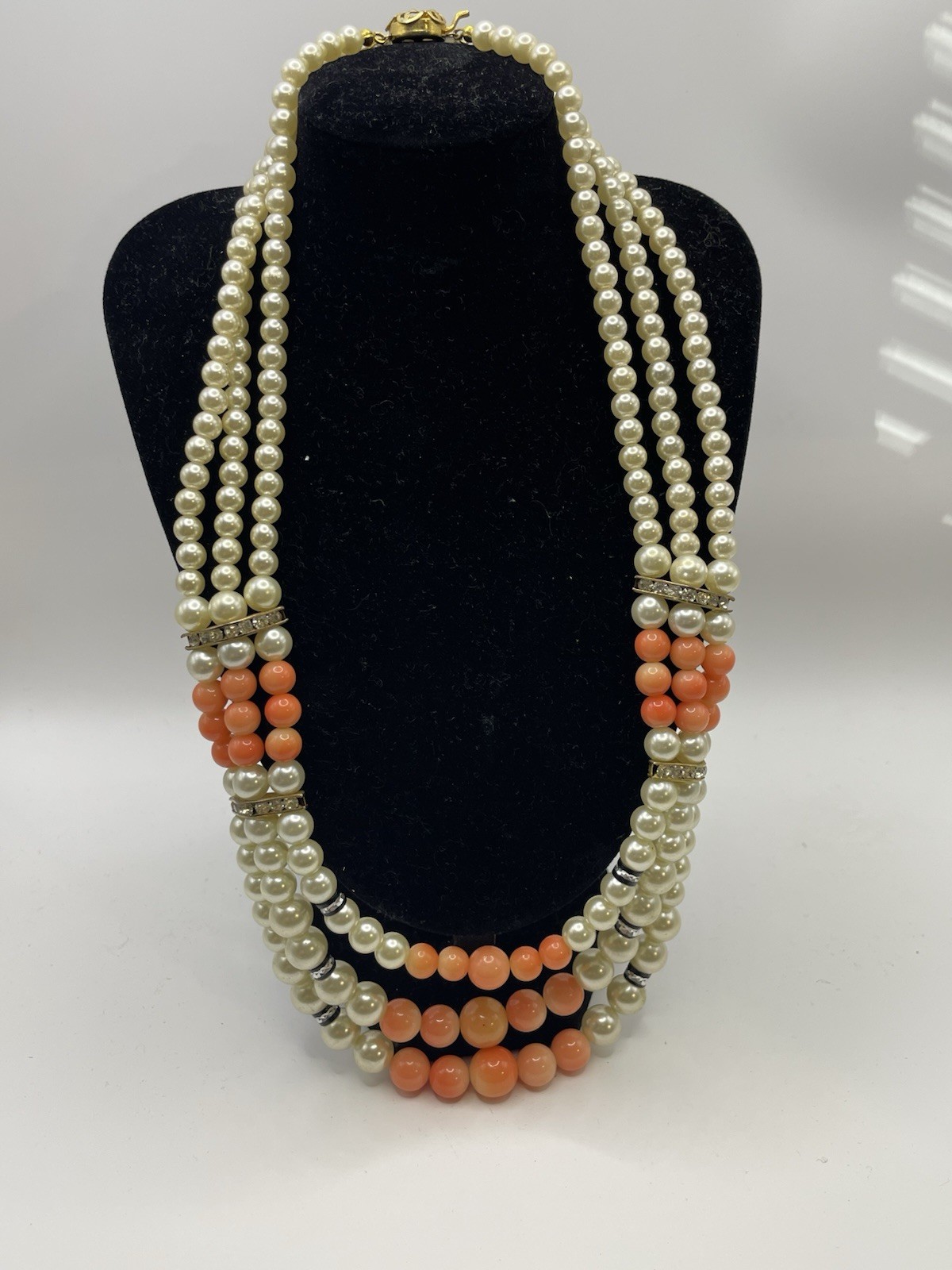 Vintage ivory and coral triple strand pearl necklace with gold tone clasp 20”