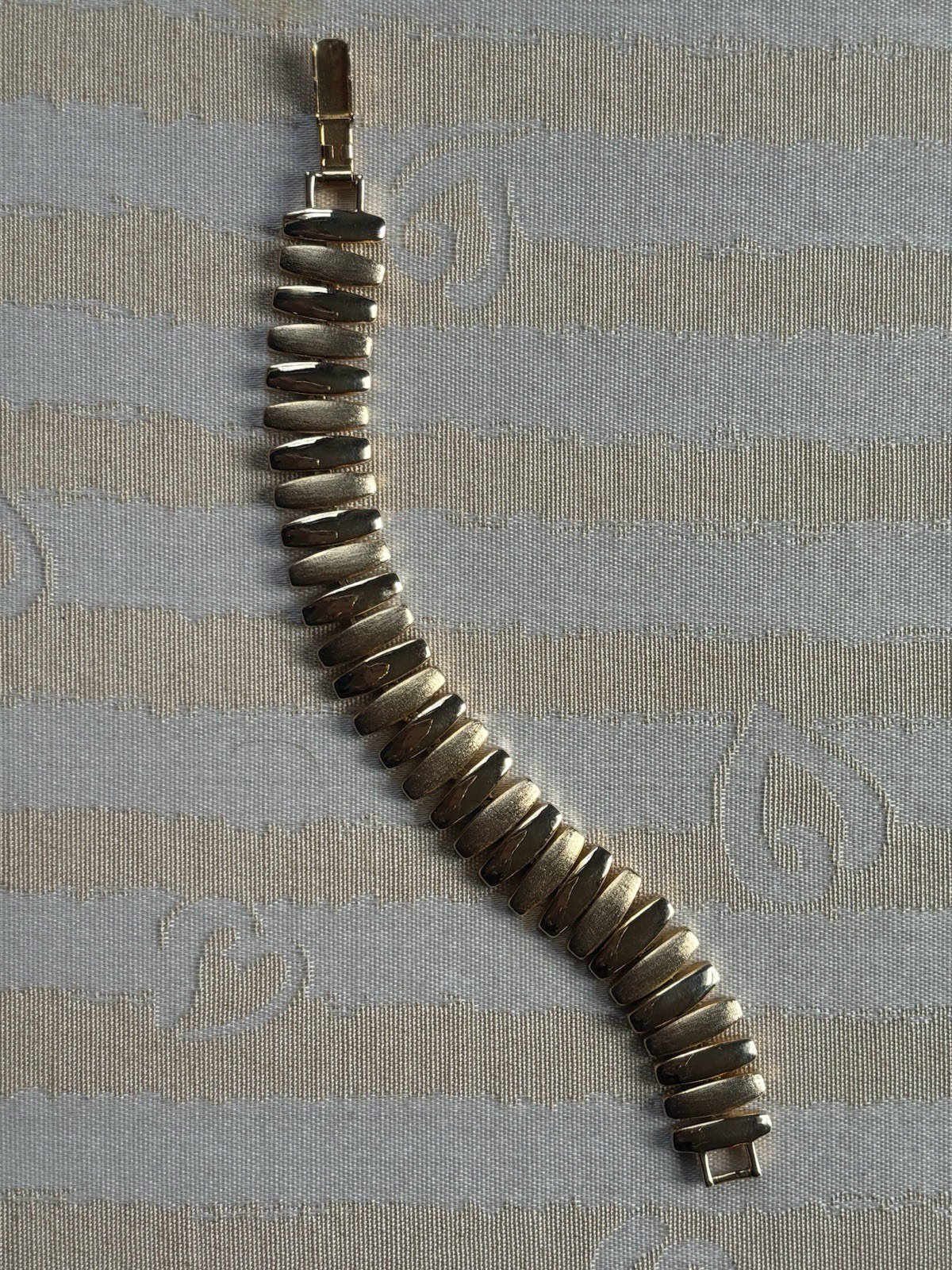 Vintage Napier gold-tone link bracelet featuring articulated, curved links 6.5”