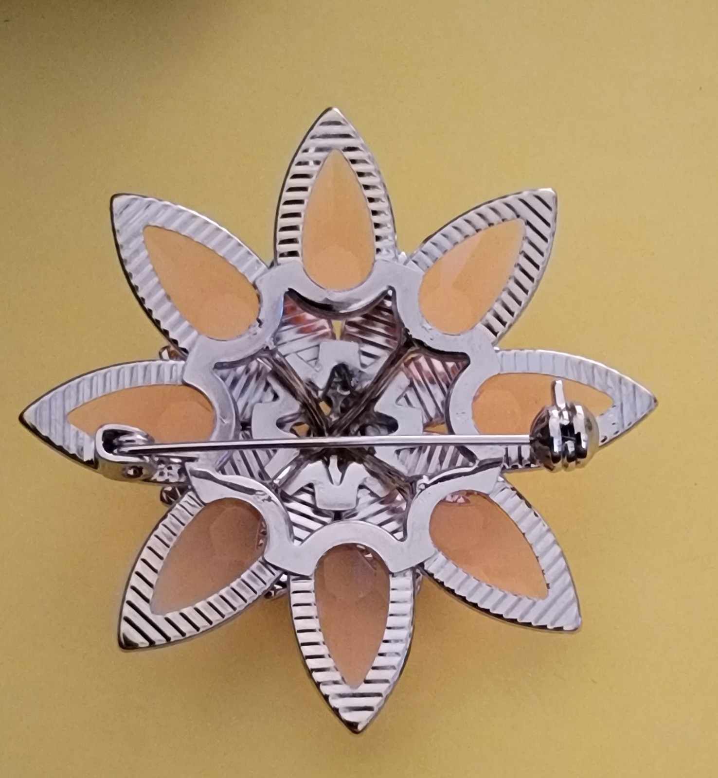 Coral-colored and translucent tiered flower brooch pin