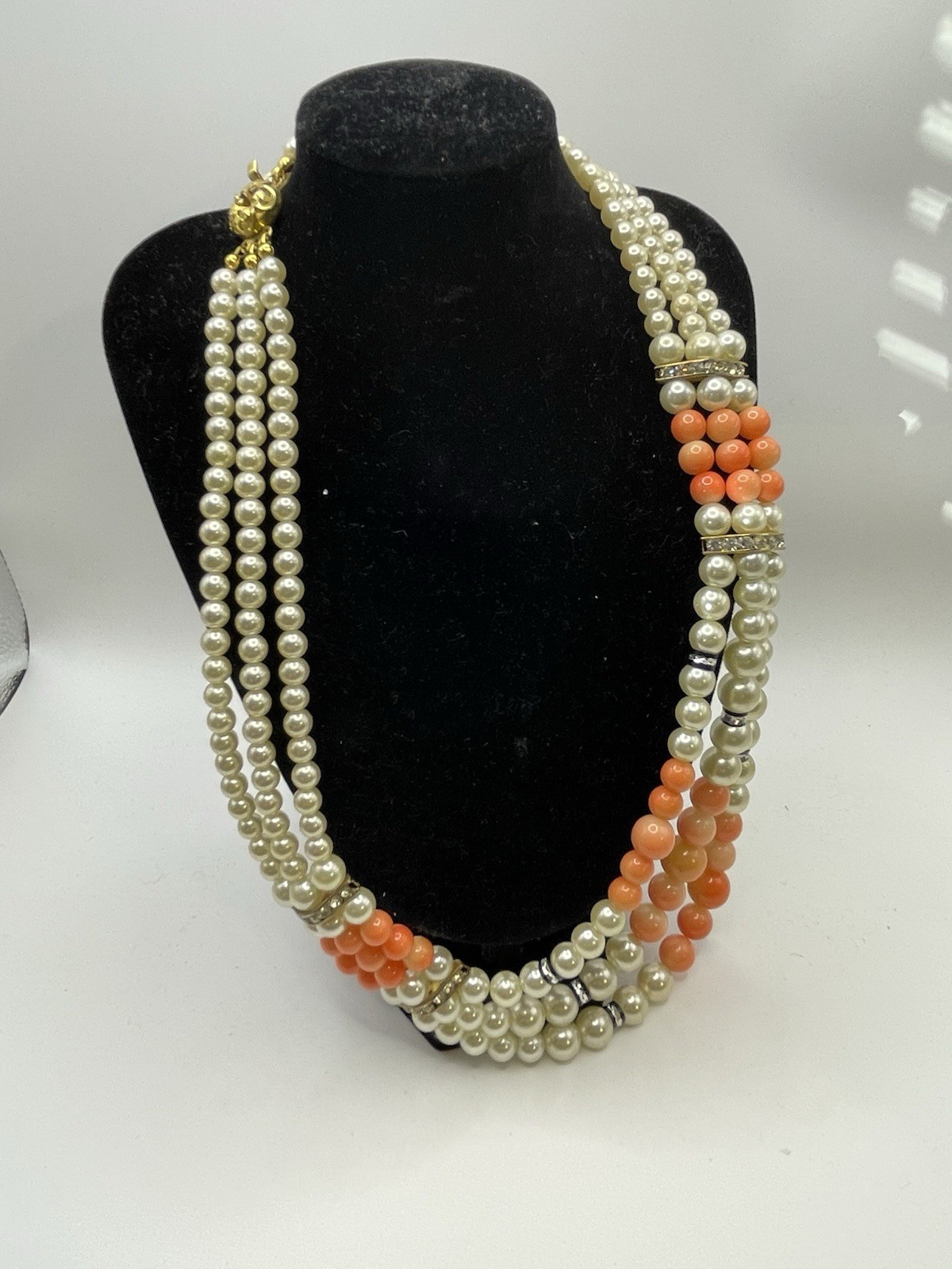 Vintage ivory and coral triple strand pearl necklace with gold tone clasp 20”
