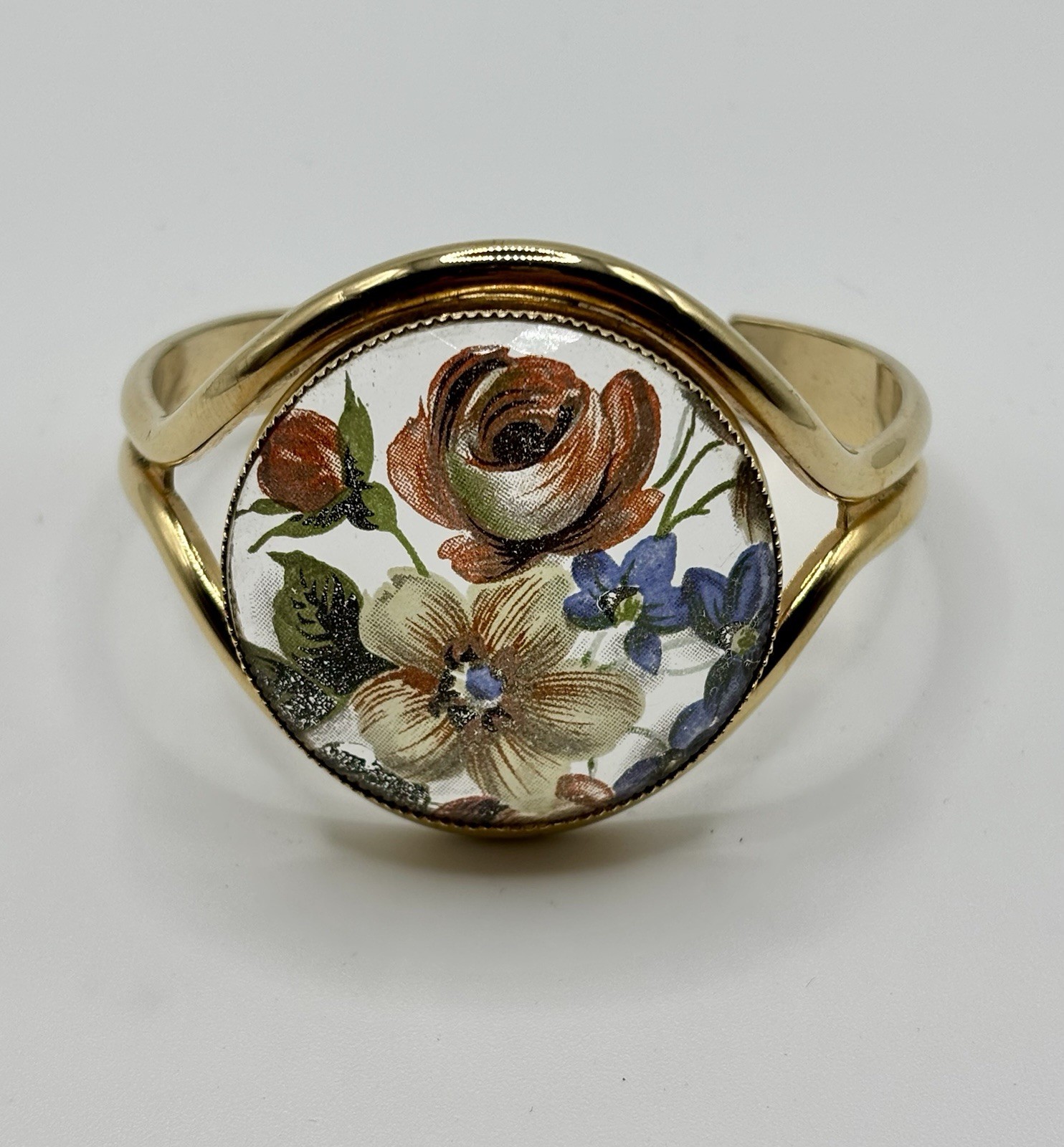 Vintage French flower medallion cuff bracelet gold-toned metal and resin.