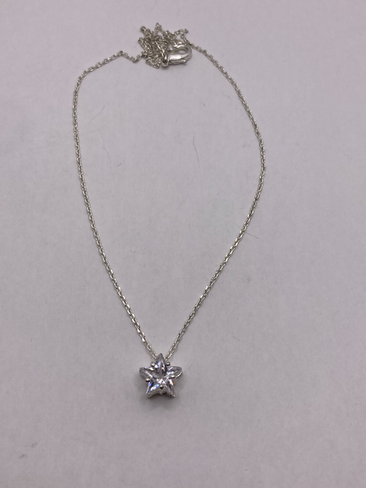 Shimmering Star-Shaped Clear Stone on Delicate Silvertone Necklace