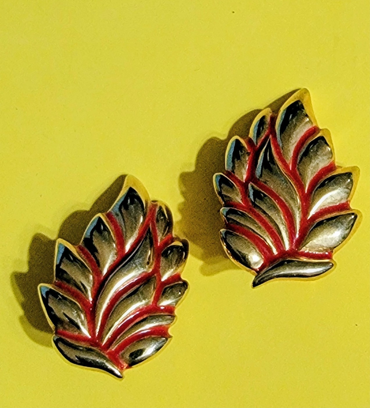 Vintage clip-on leaf design earrings with red enamel accents and polished go